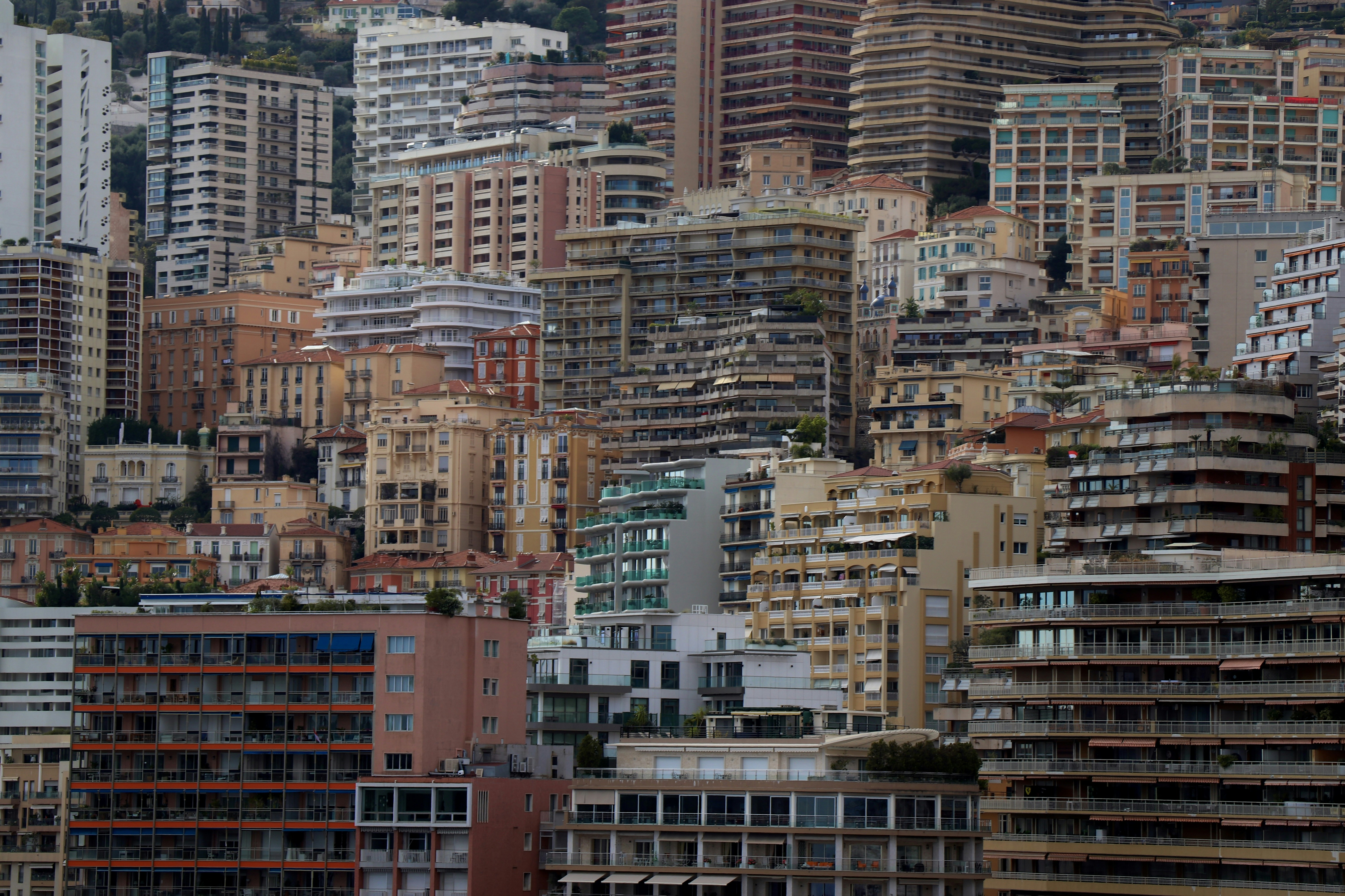 A dense urban landscape of high-rise apartment buildings stacked on a hillside in Monaco