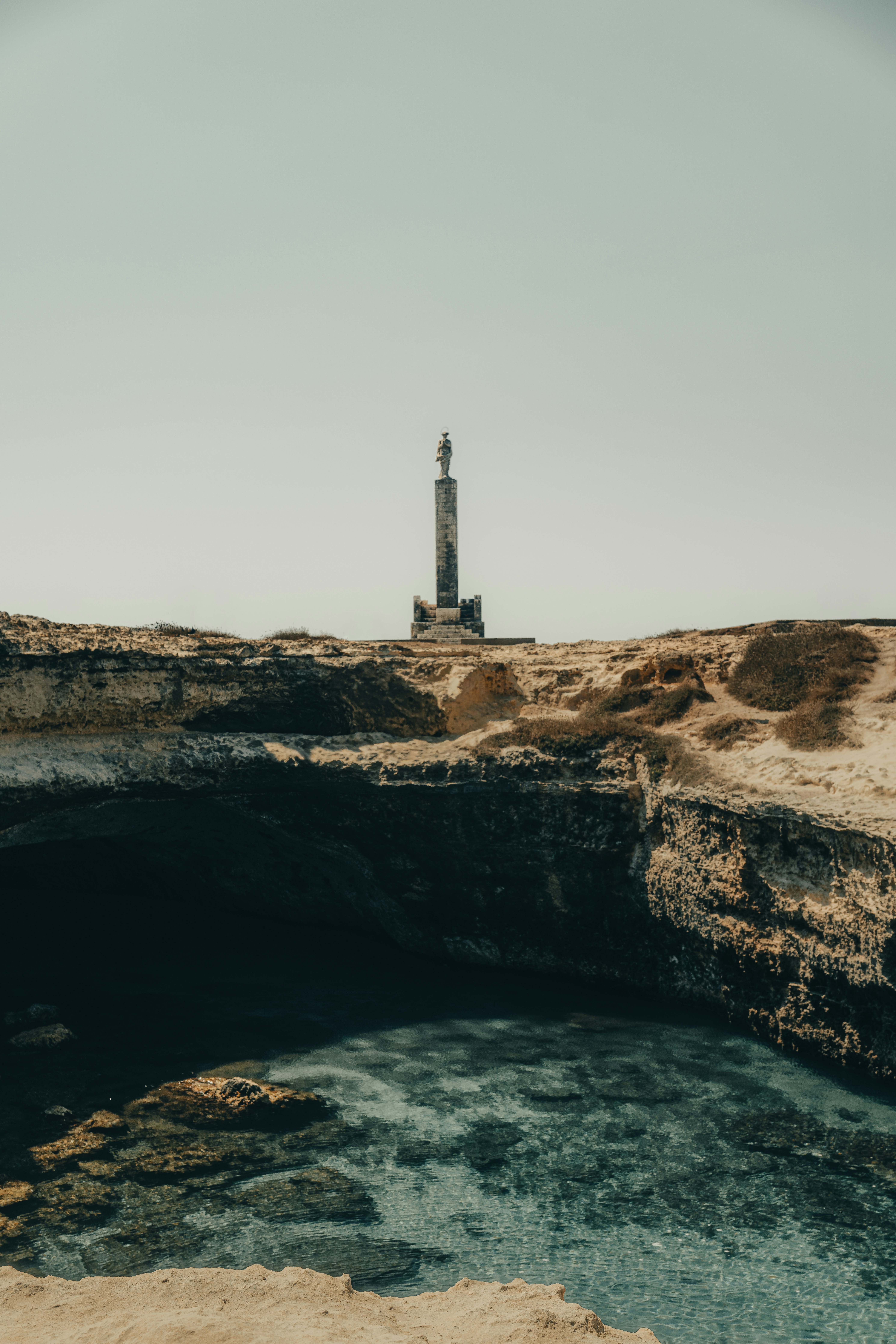 Stone monument on rocky coast - Free Photo on Unsplash