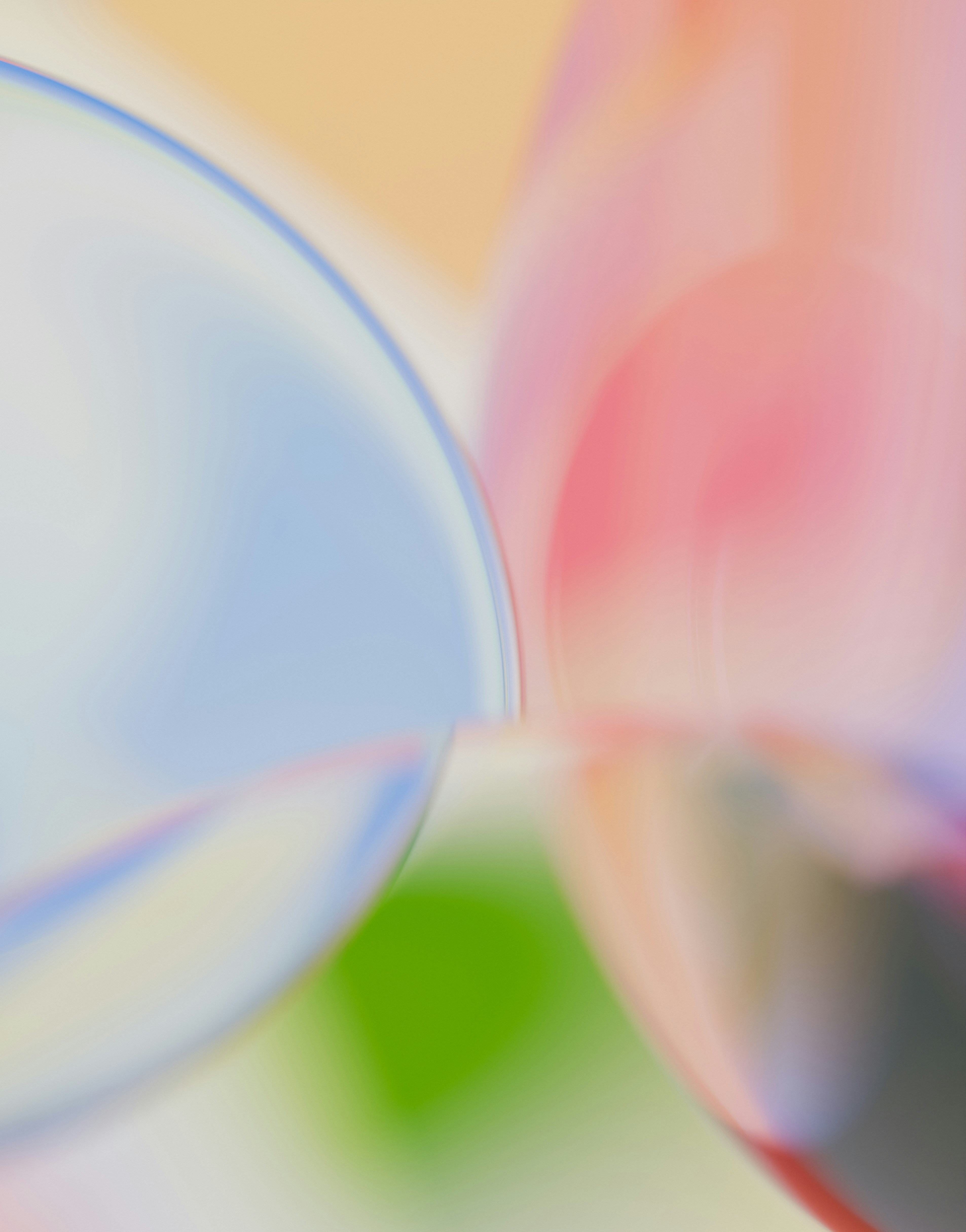 Abstract blurred shapes in soft blue, pink, and green tones