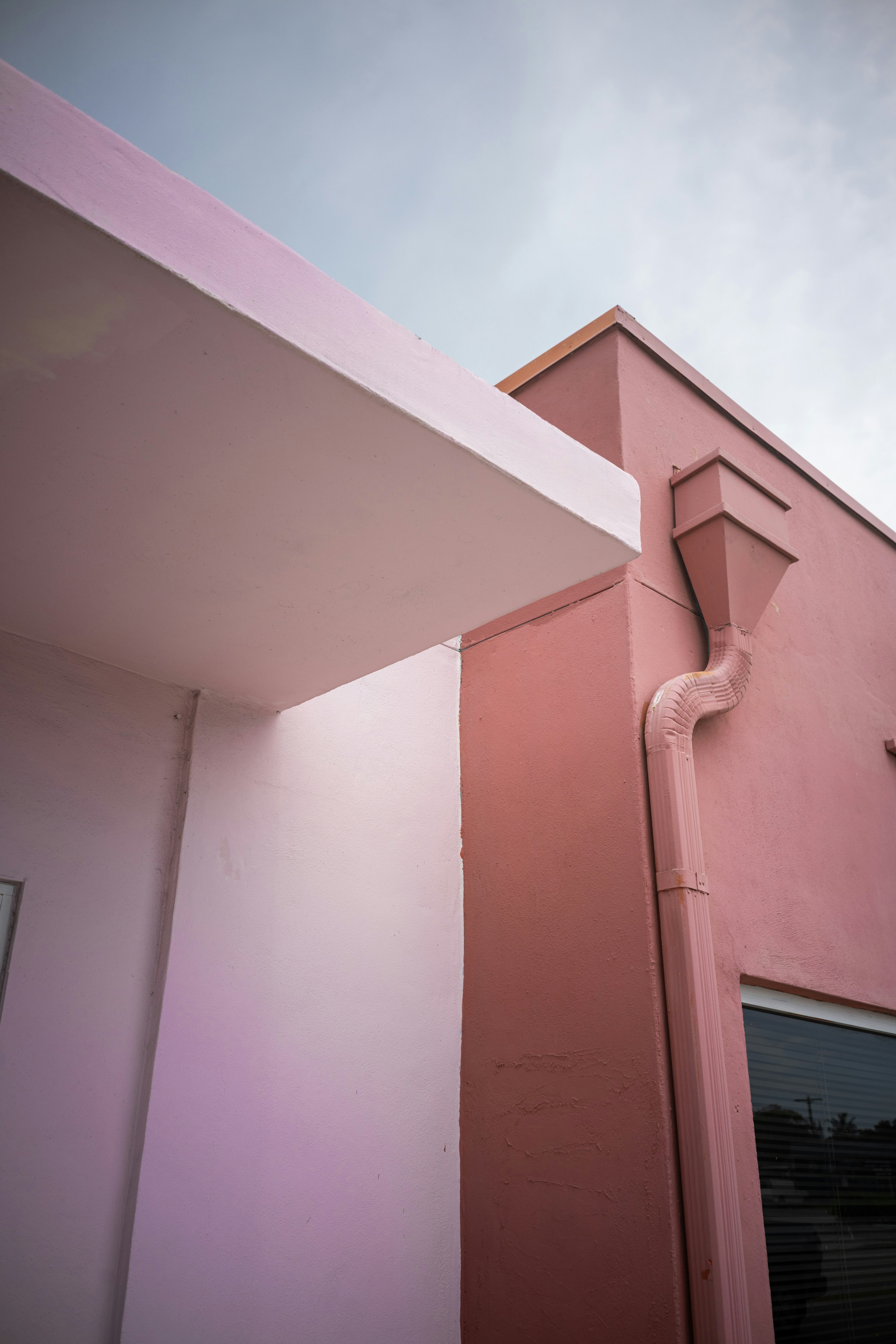 Pink building exterior with downspout - Free Photo on Unsplash