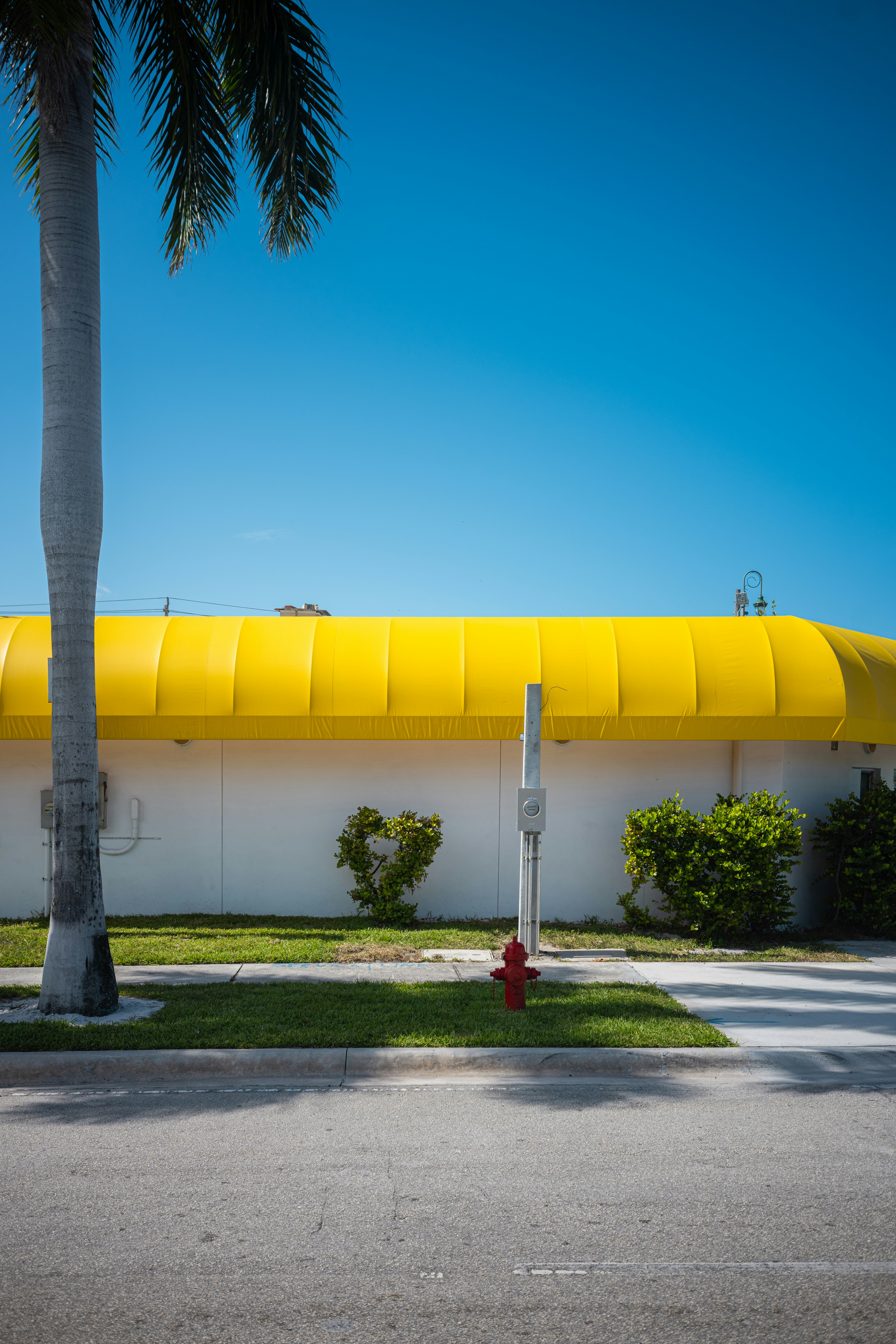 Yellow awning on white building - Free Photo on Unsplash