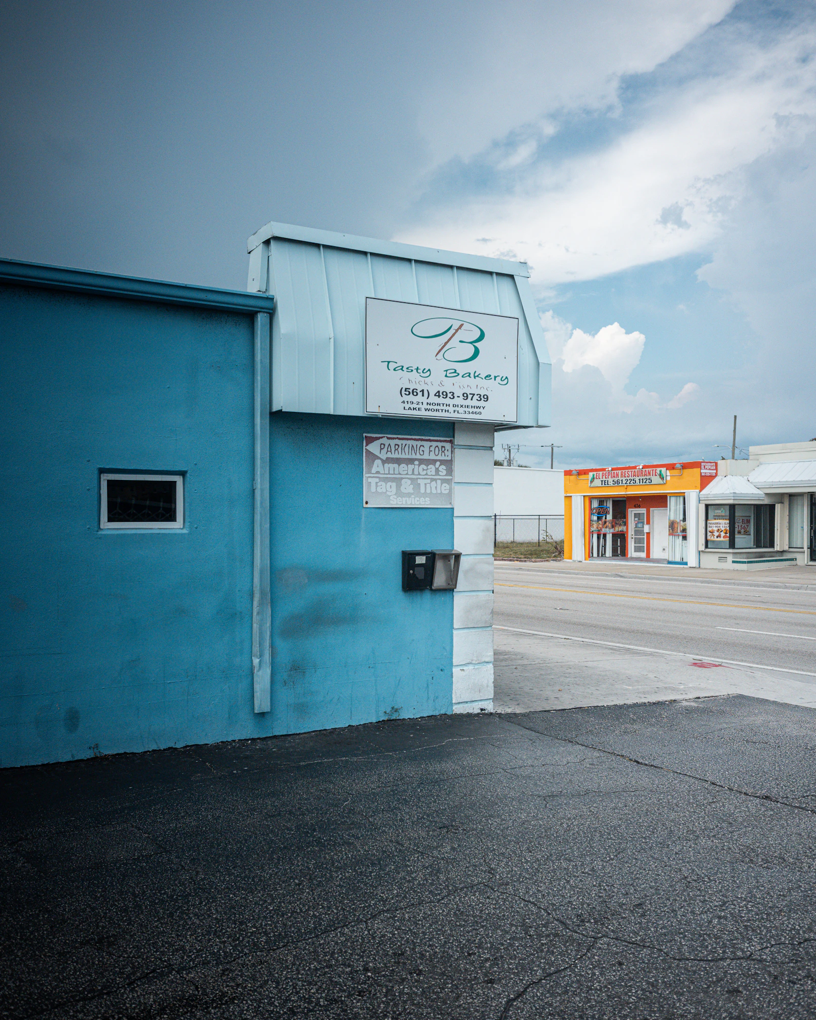 A bright blue family-run bakery storefront in Lake Worth, Florida