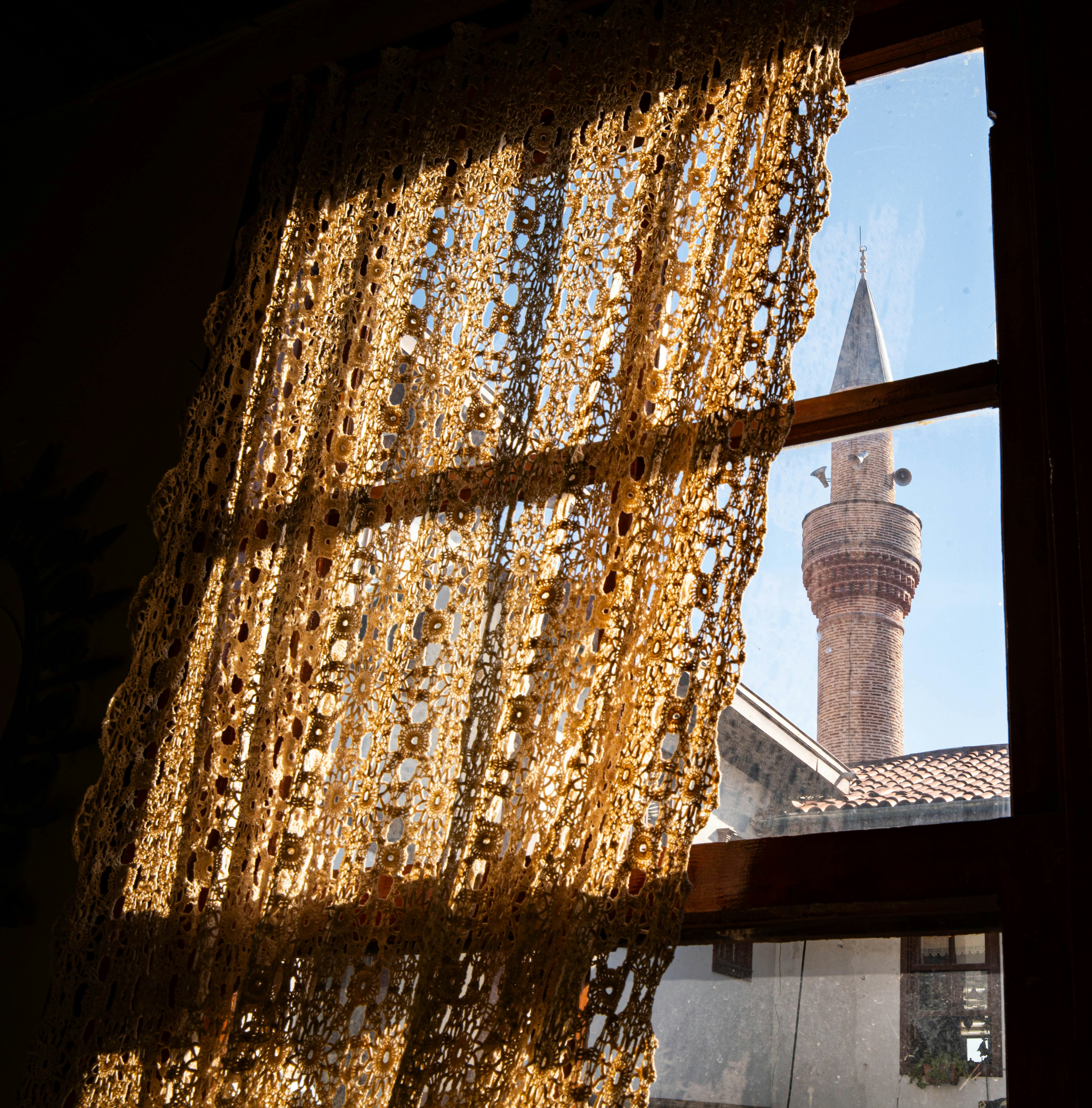 Minaret seen through window with curtain - Free Photo on Unsplash