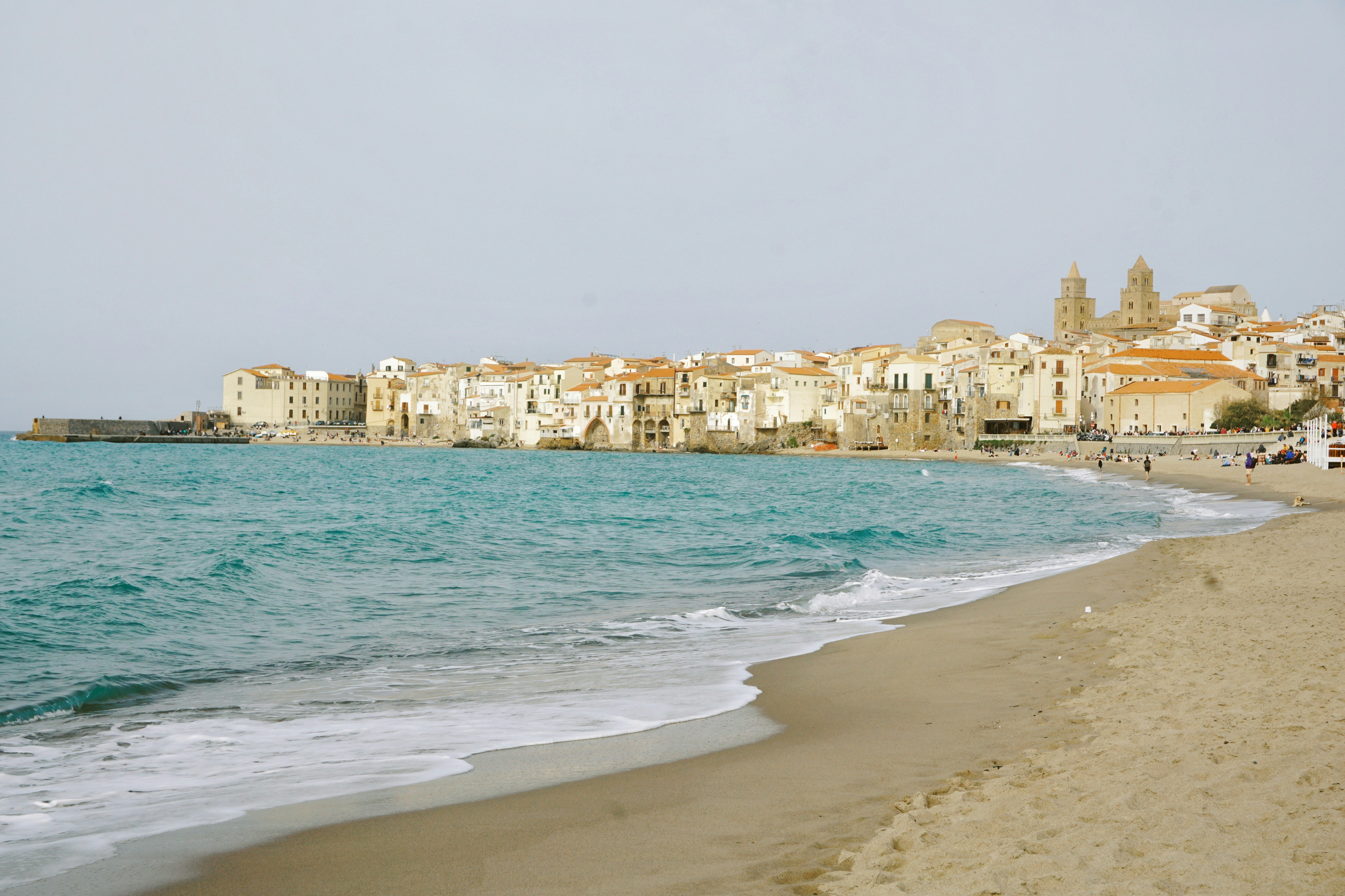 The coastal town of Cefalù with its sandy beach and turquoise water in Sicily