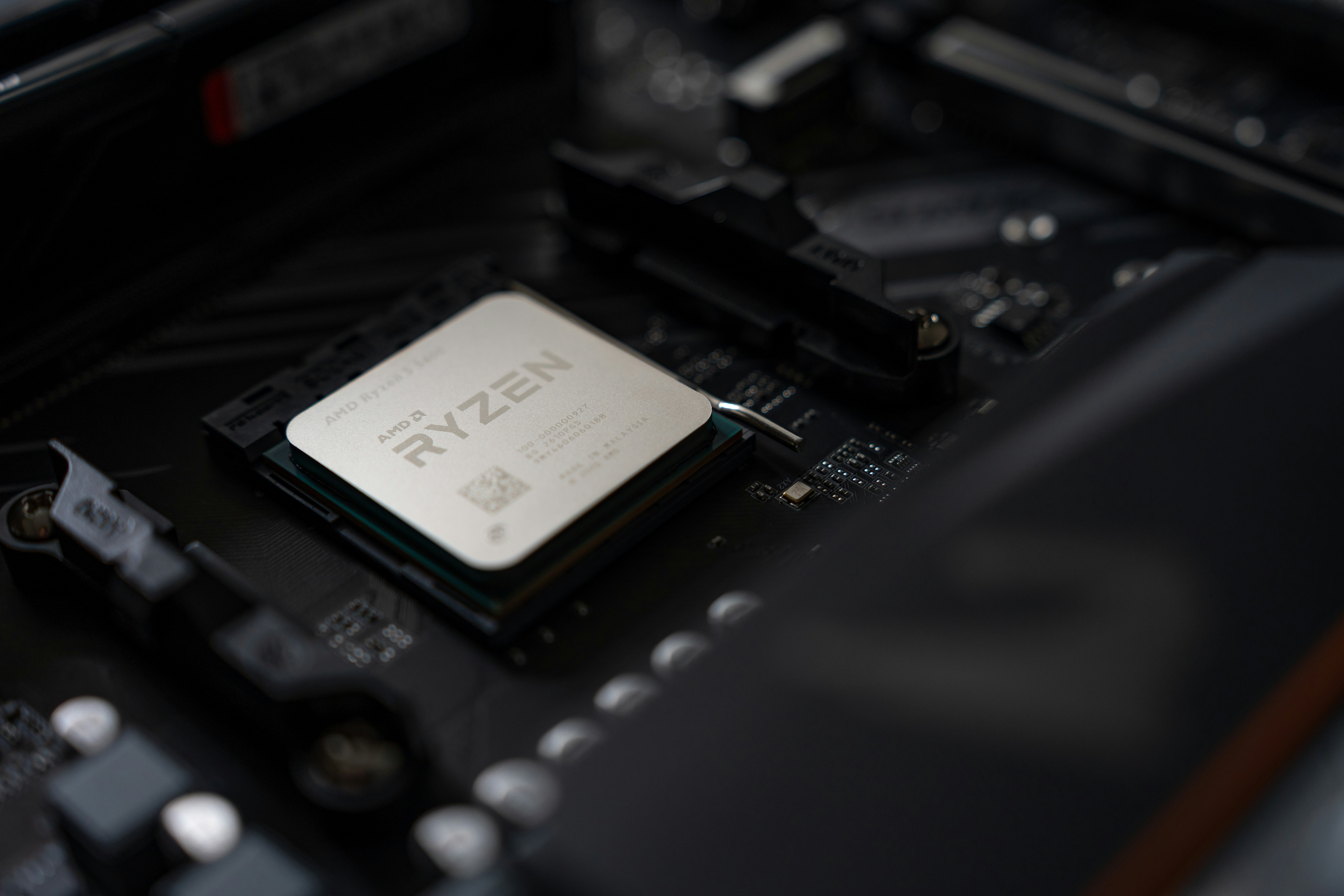 An AMD Ryzen processor installed in a black computer motherboard socket