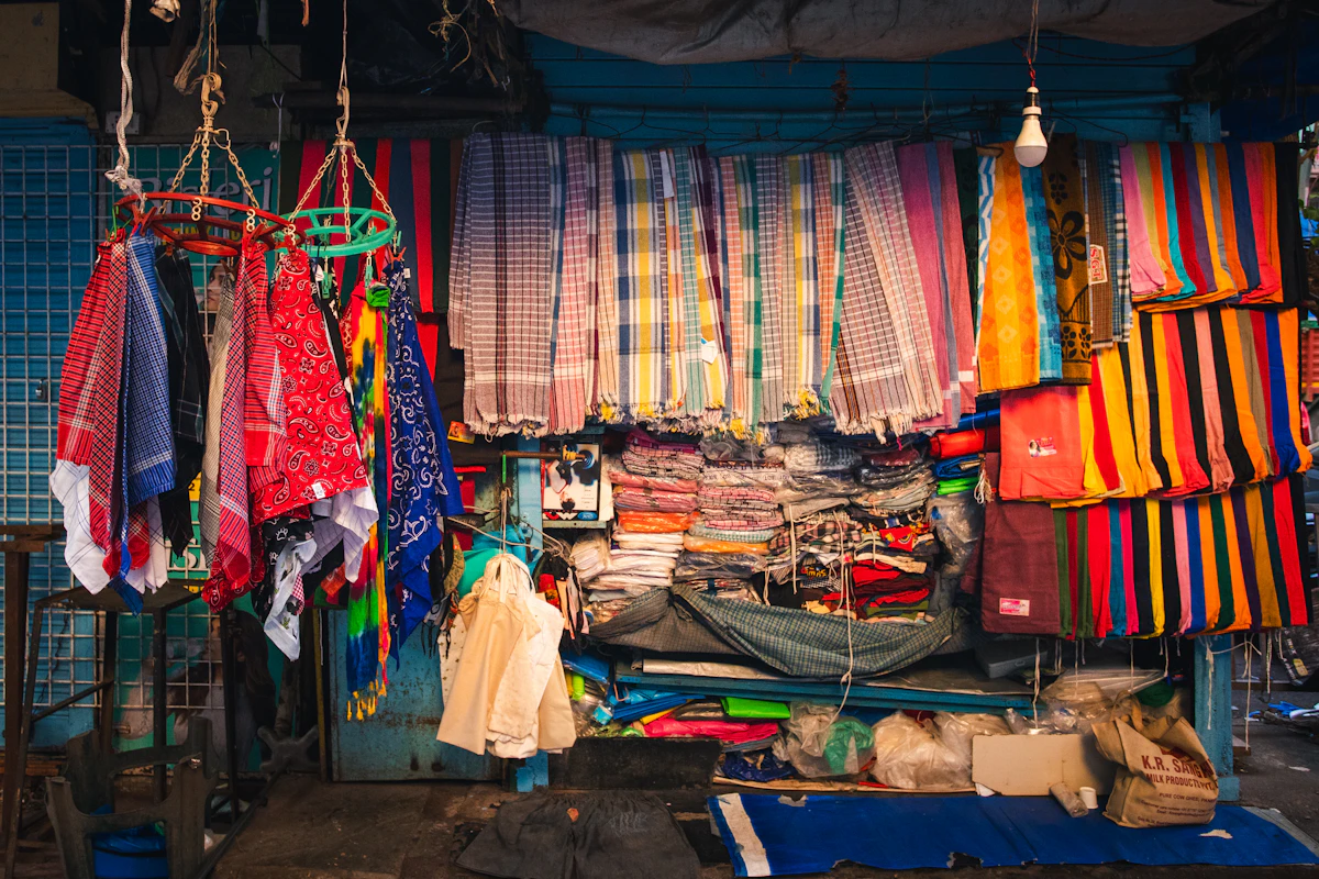 Patterned fabrics hanging in a small market stall
