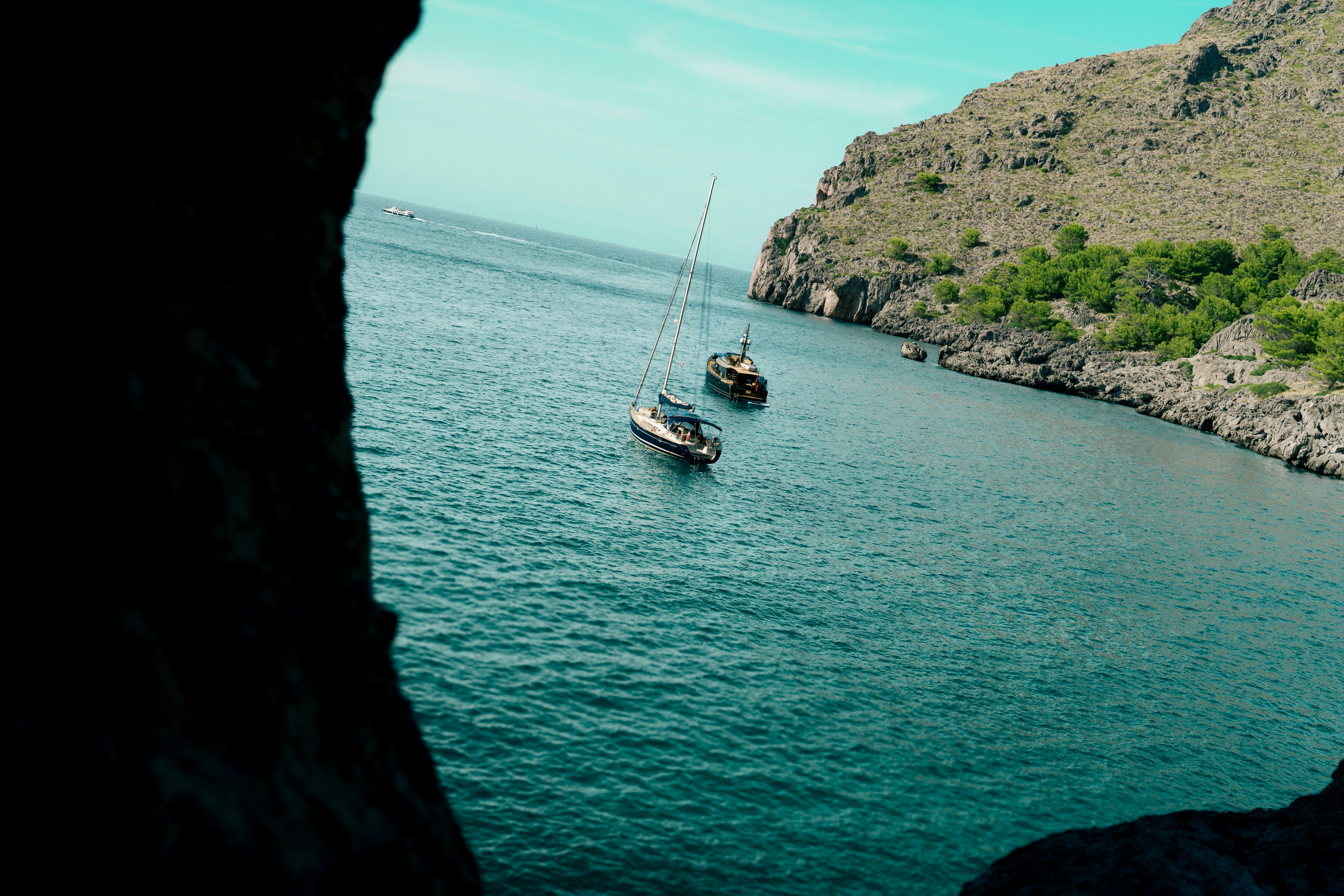 Two sailboats on the blue water of Sa Calobra in Mallorca, Spain