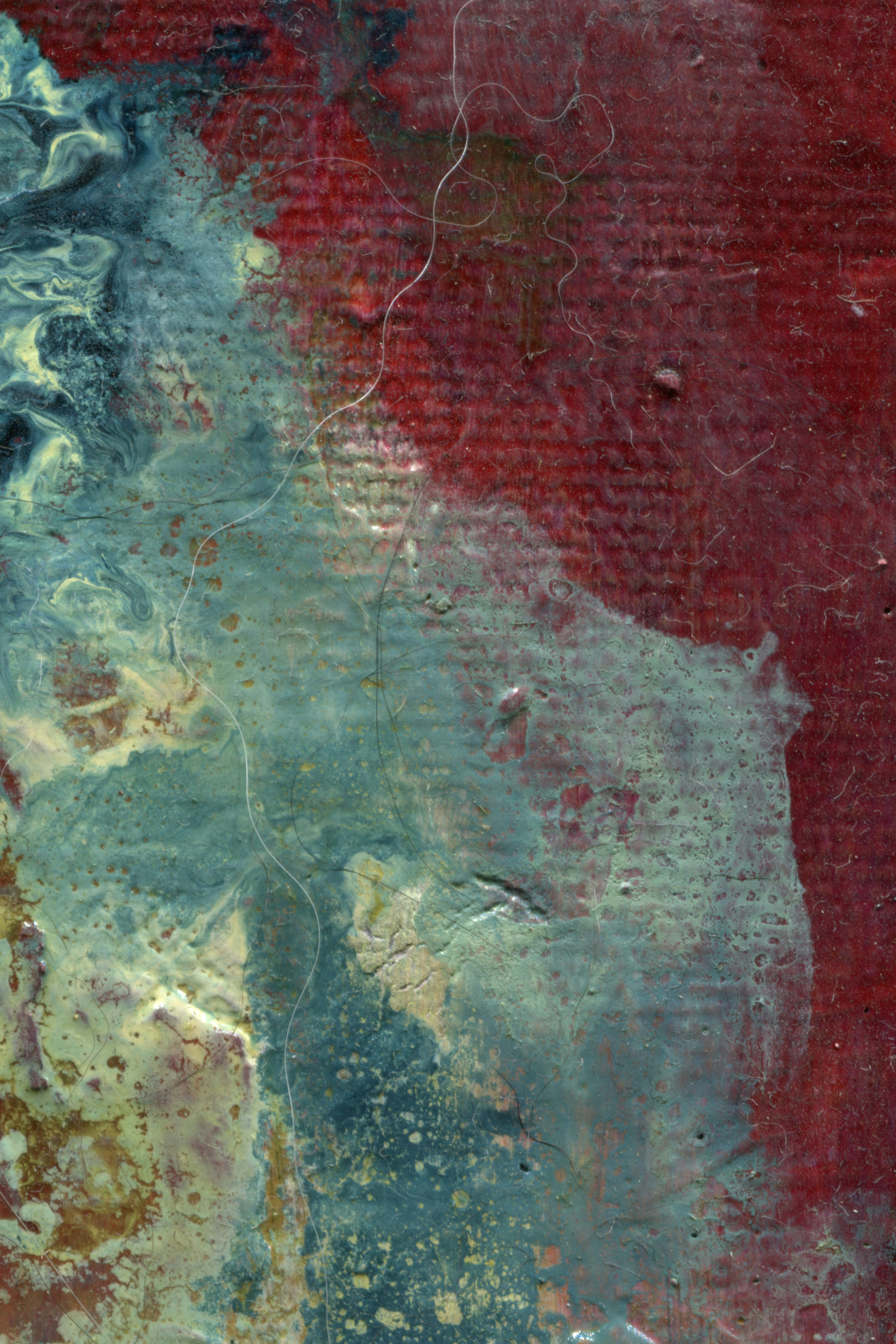A painting of abstract red and teal textured layers with fine stray fibers