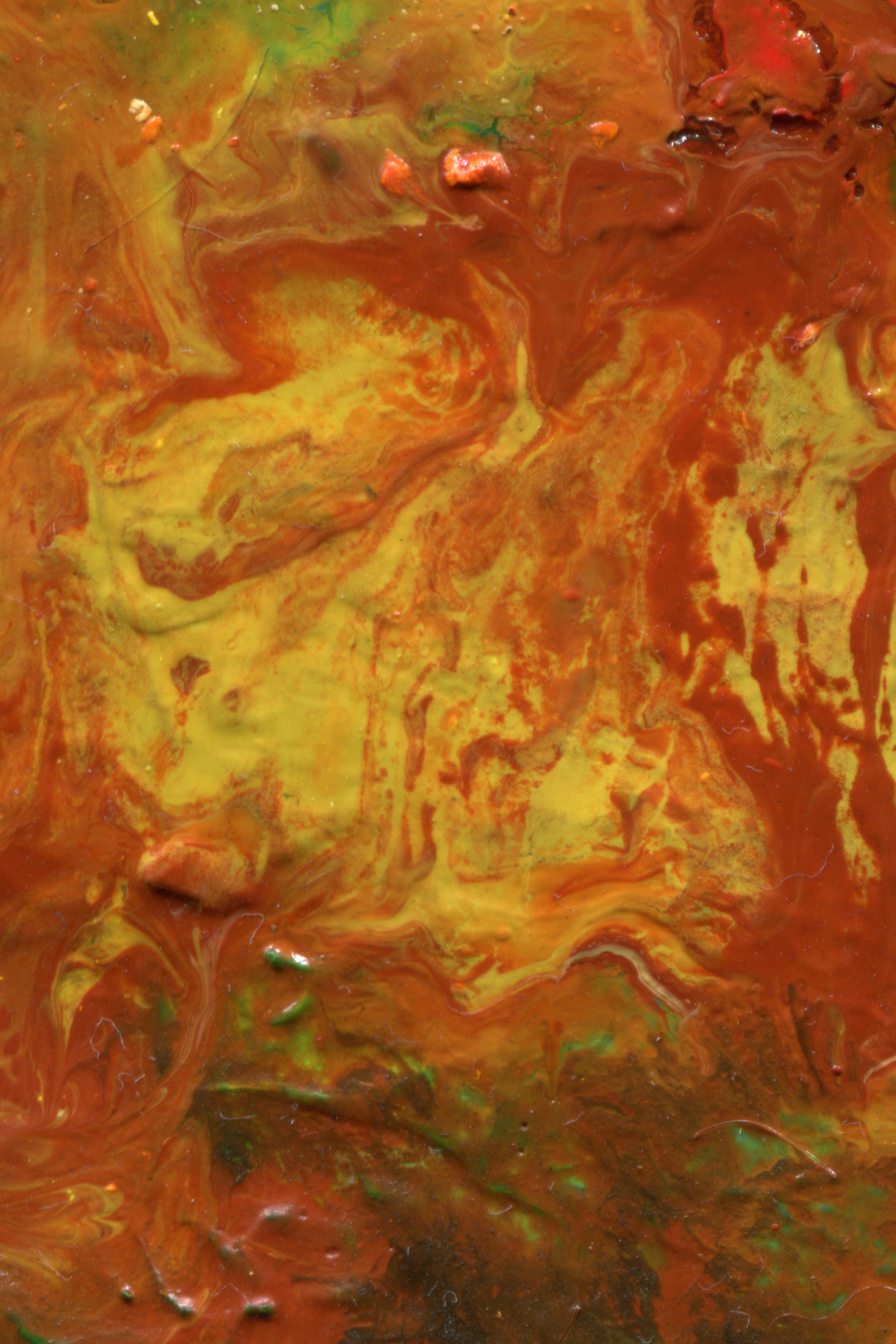 A painting of swirling yellow and rust red paint with patches of green