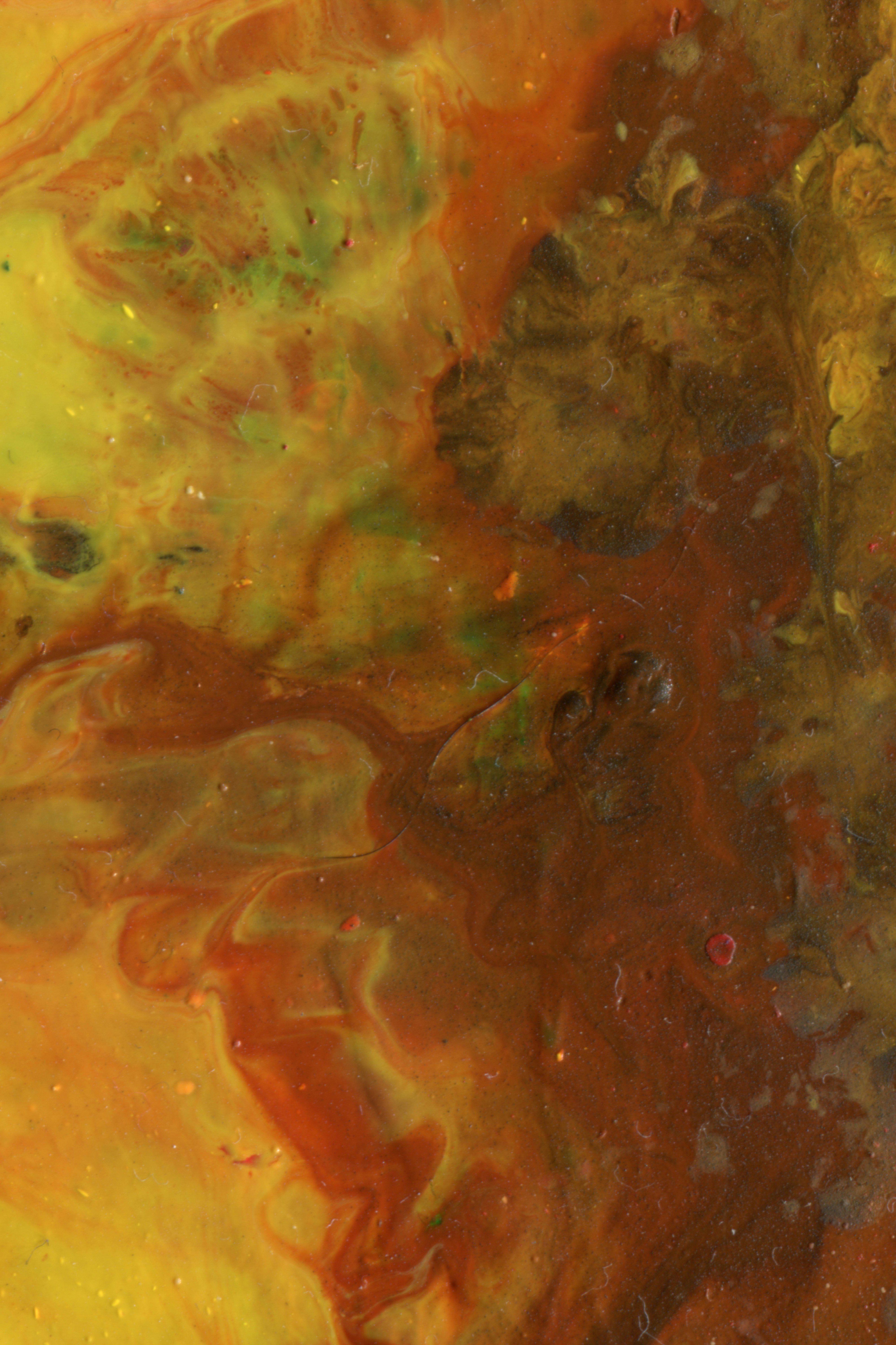 Swirling patterns of yellow, orange, and brown paint with a glossy texture