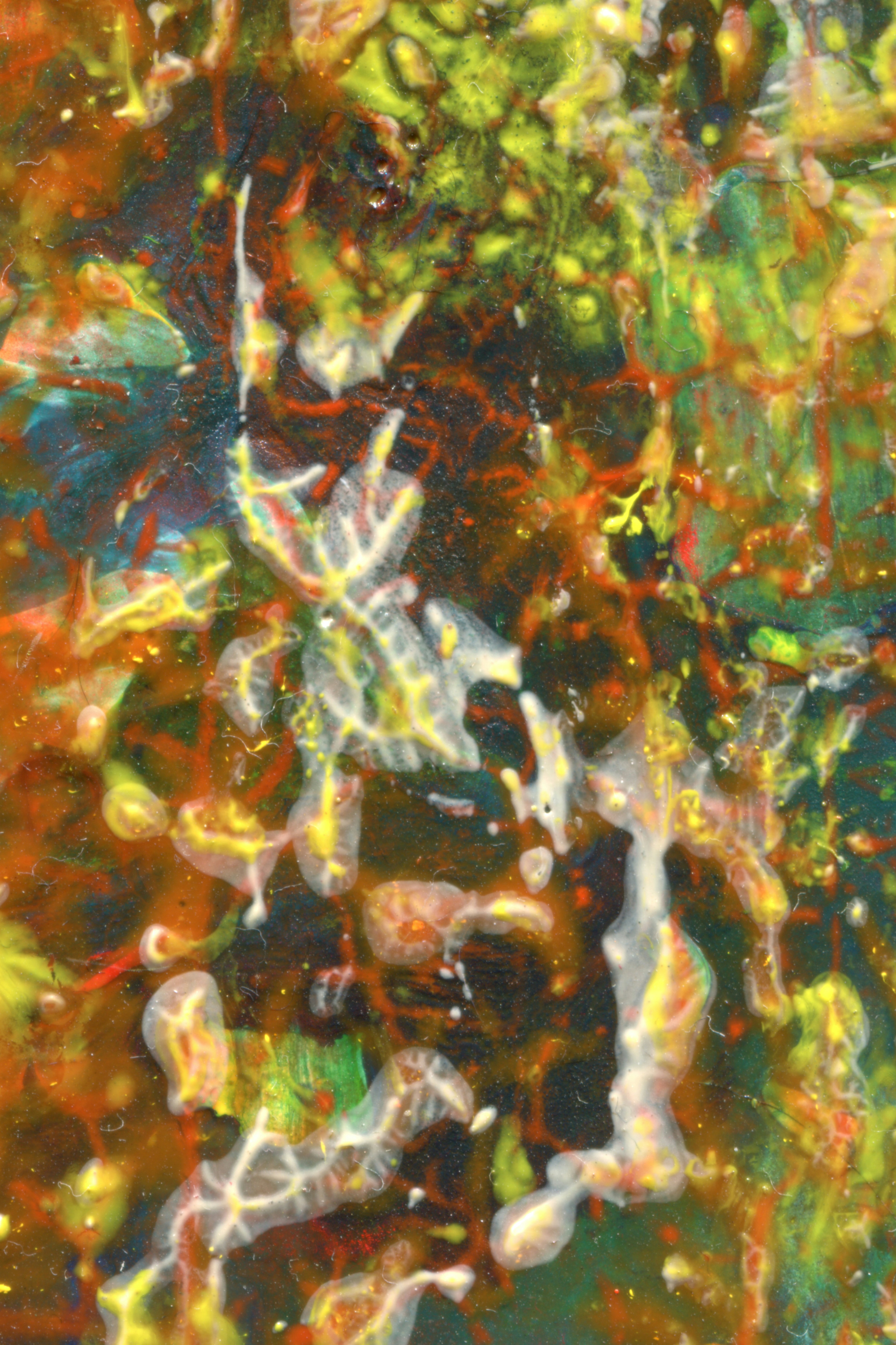 Abstract painting with layered textures in vibrant shades of red, yellow, and green