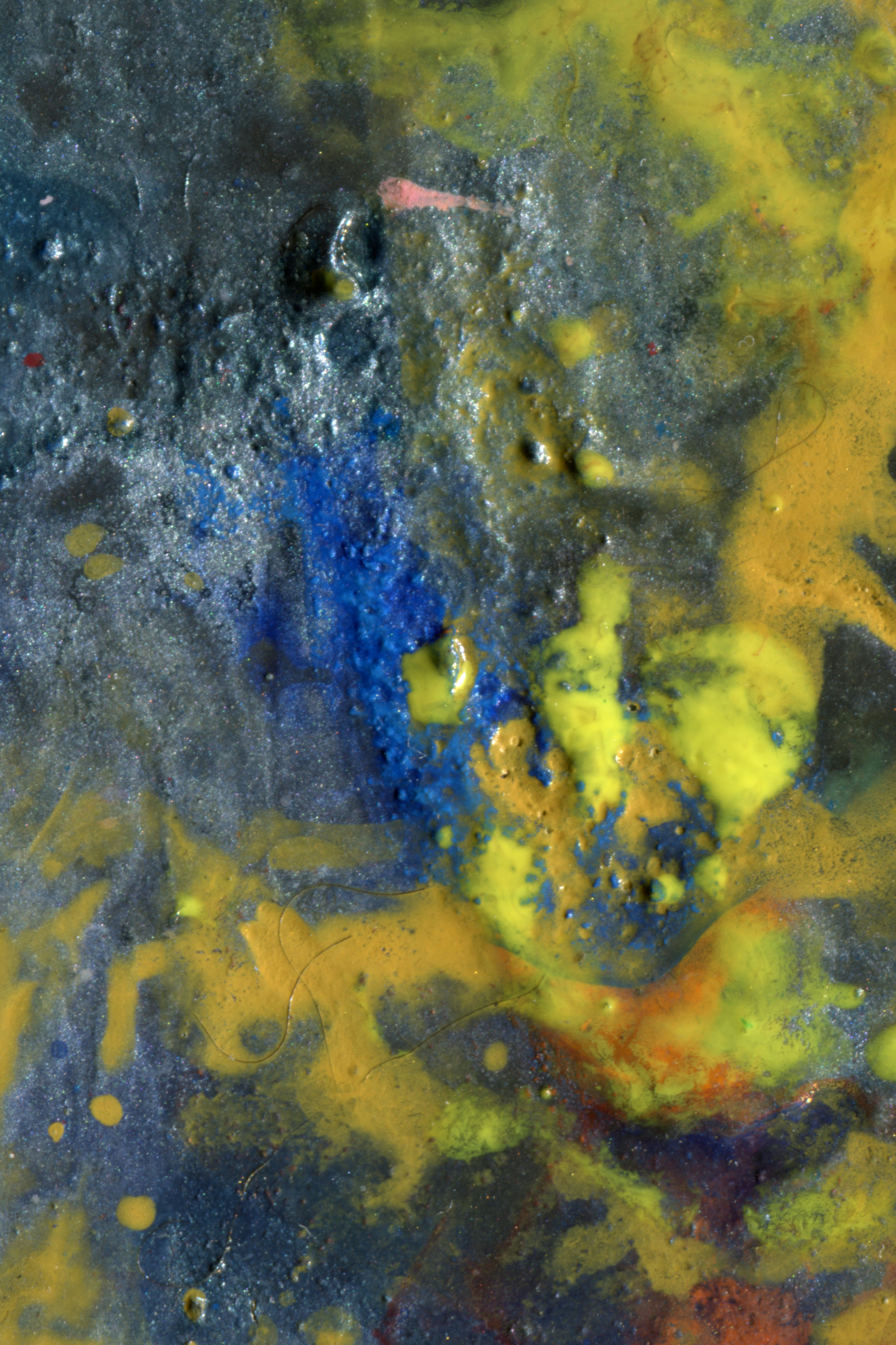 Abstract texture of thick blue and yellow paint with a glossy finish
