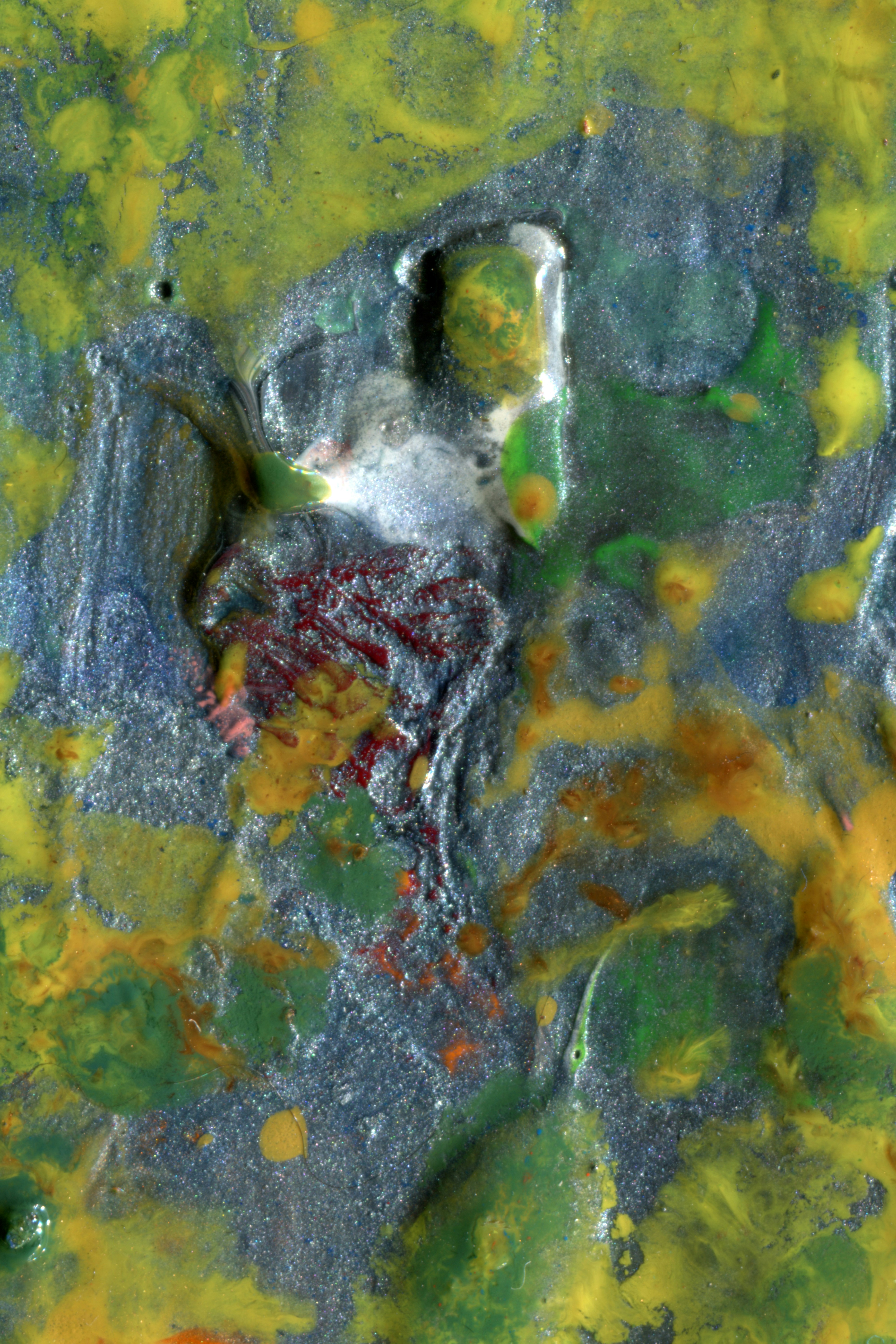 Swirls of thick blue, green, and yellow paint with a textured metallic finish