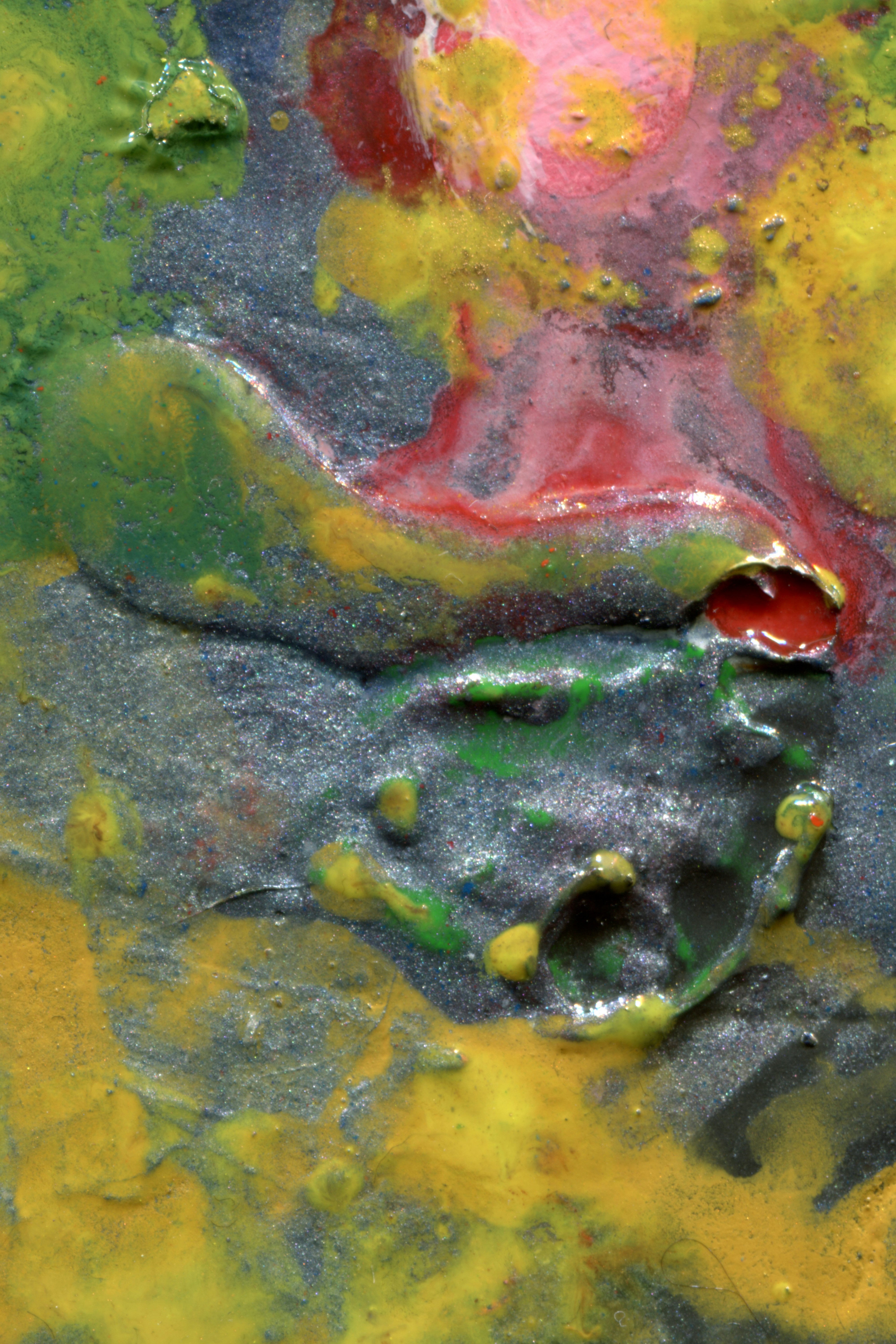 A thick layer of wet, swirled paint in shades of green, yellow, red, and metallic silver