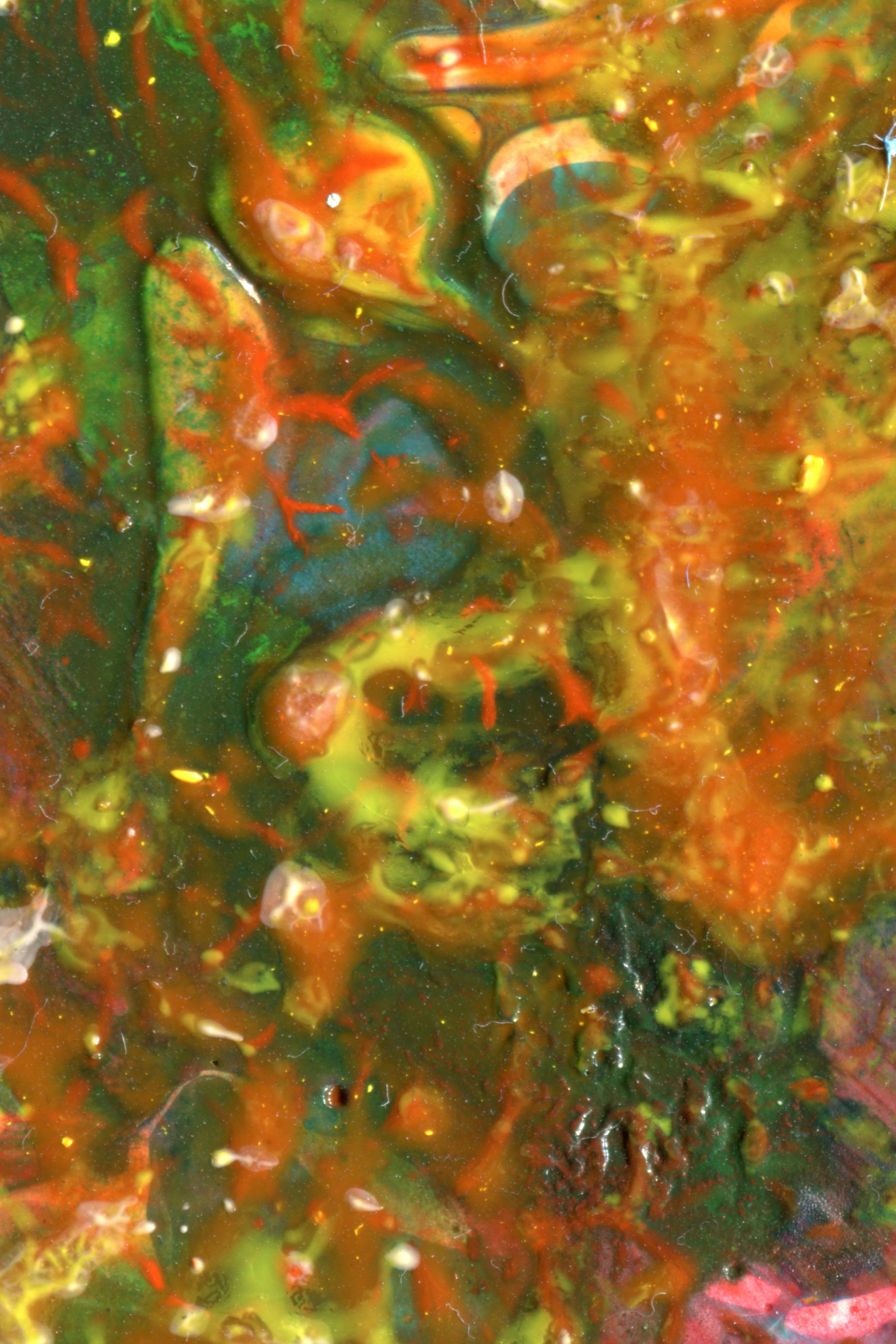 Abstract swirls of green, orange, and yellow paint with small bubbles and textured layers