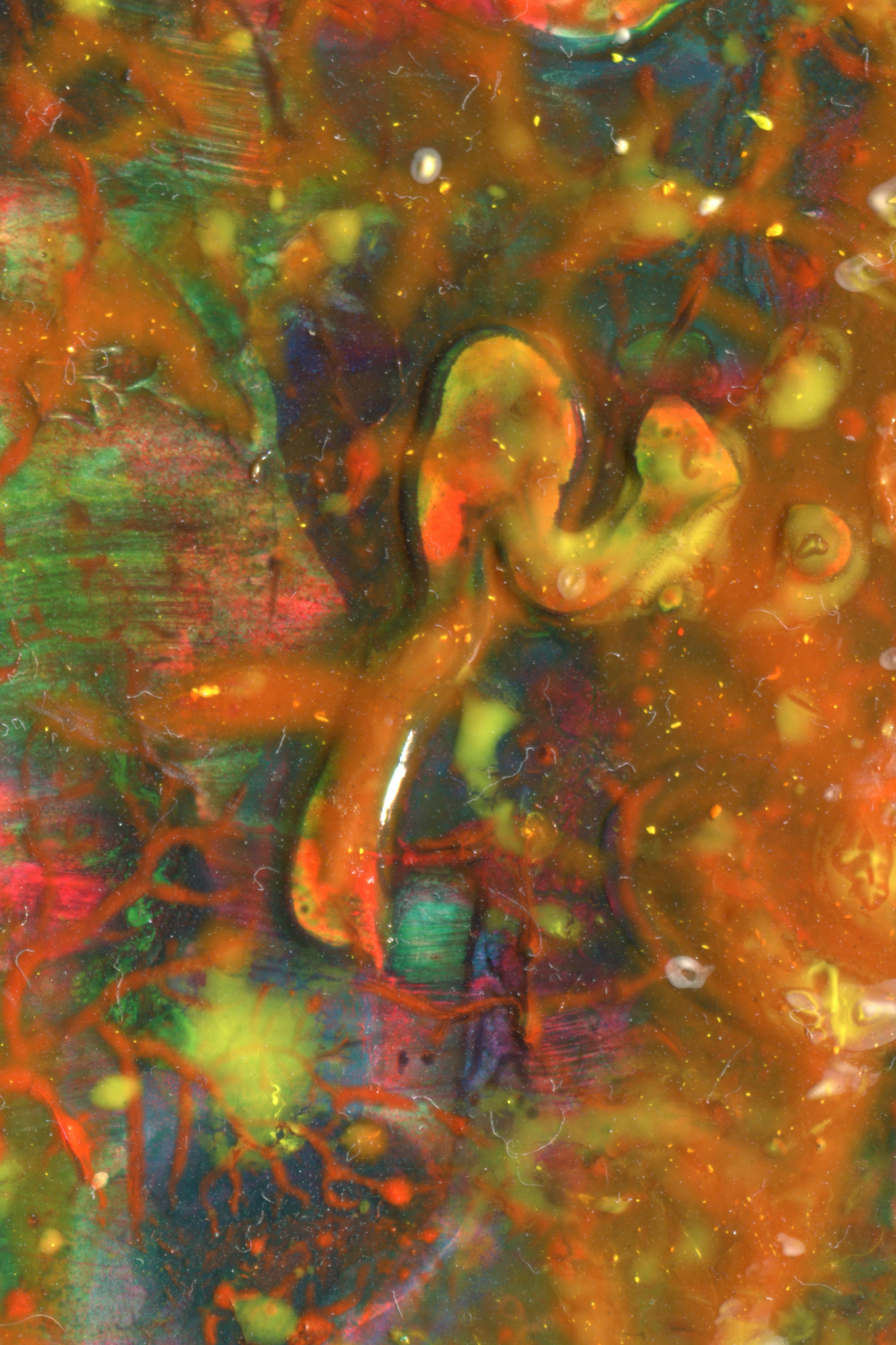 Abstract swirls of thick orange, green, and red paint with glossy textures