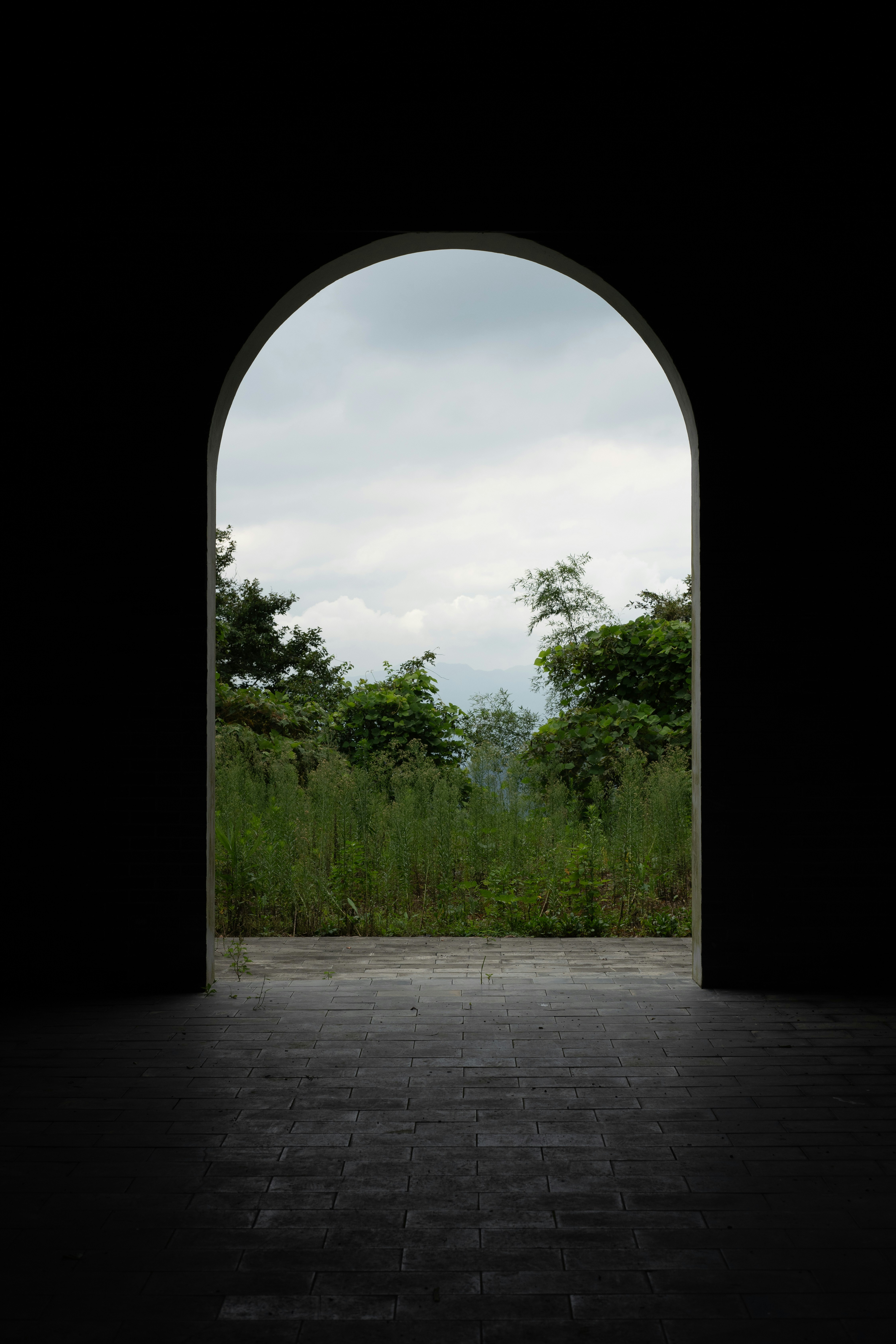 Arched doorway looking onto green landscape - Free Photo on Unsplash