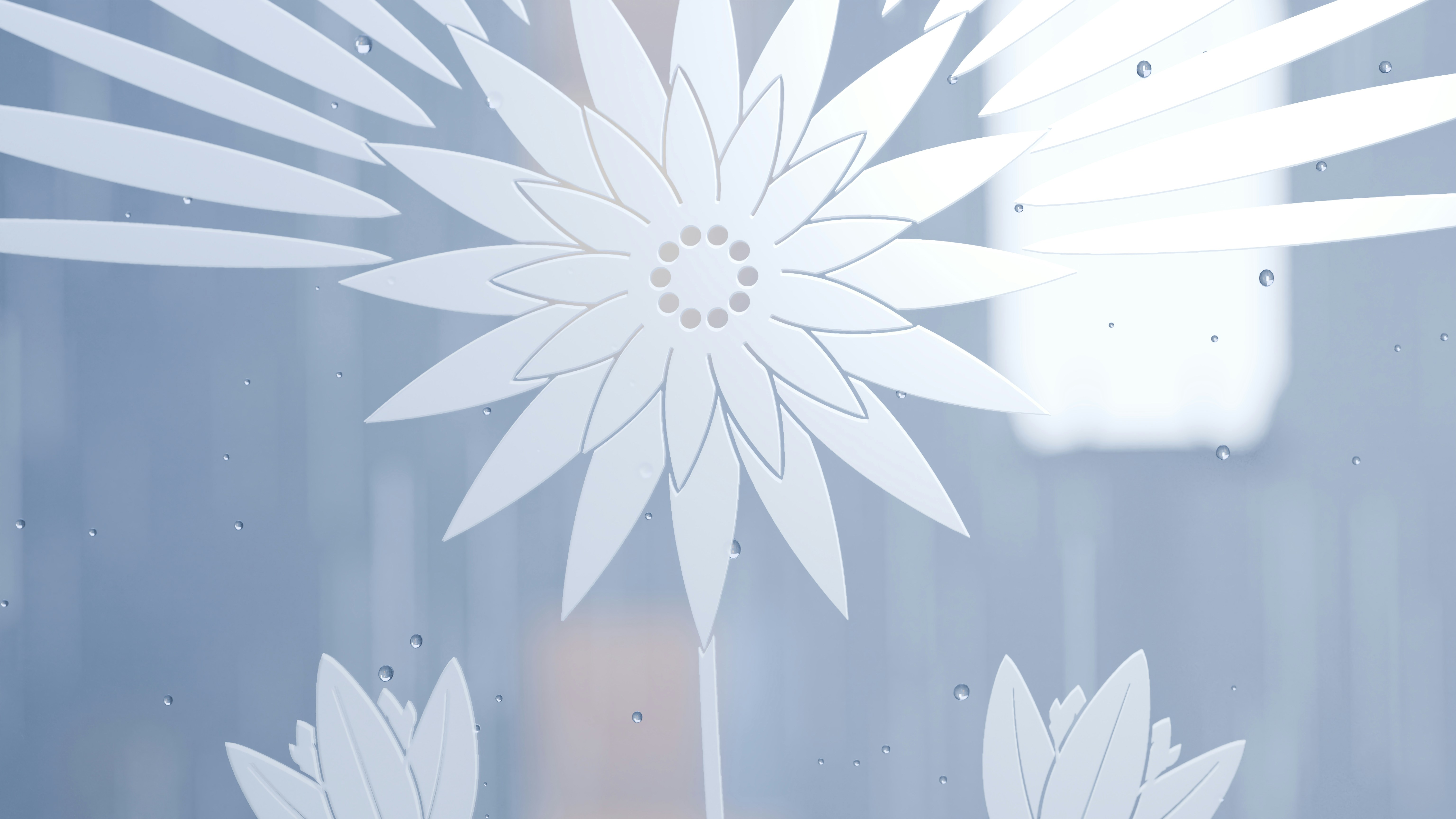 A 3D render of a frosted glass surface with a white etched floral pattern and water droplets