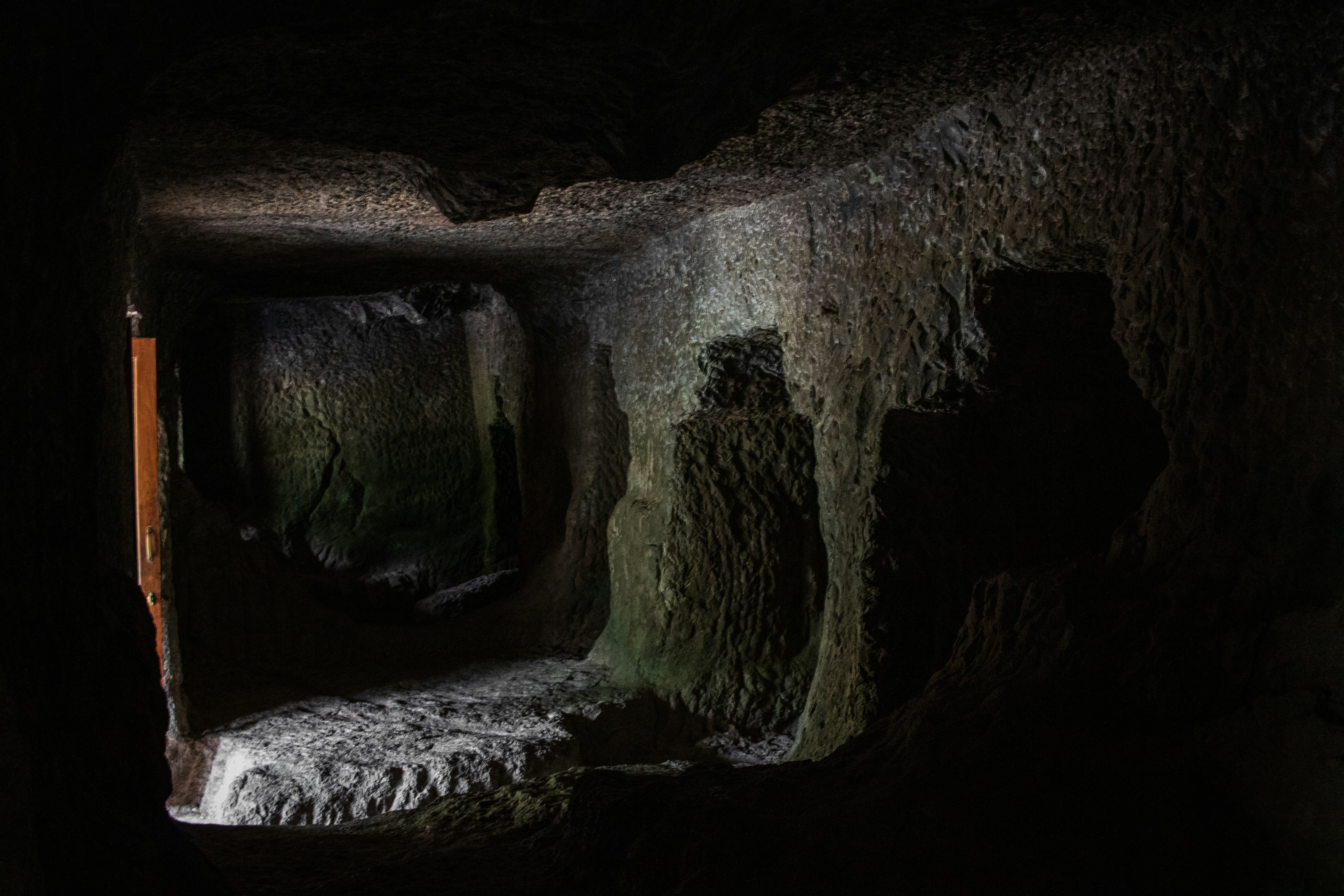The dark interior of an unfinished rock-cut cave at the Ajanta Caves in India