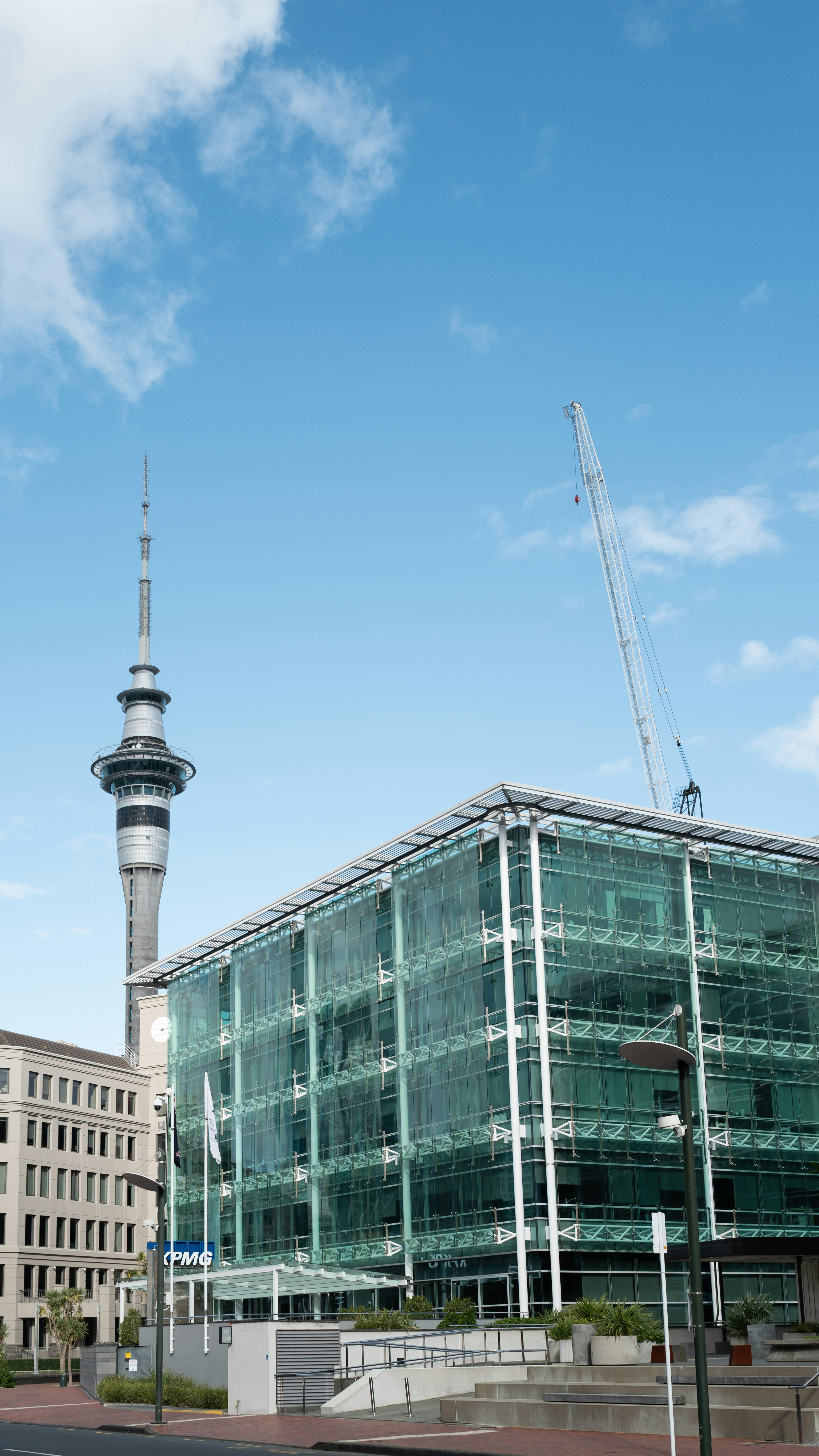 Sky Tower and glass building in Auckland - Free Photo on Unsplash