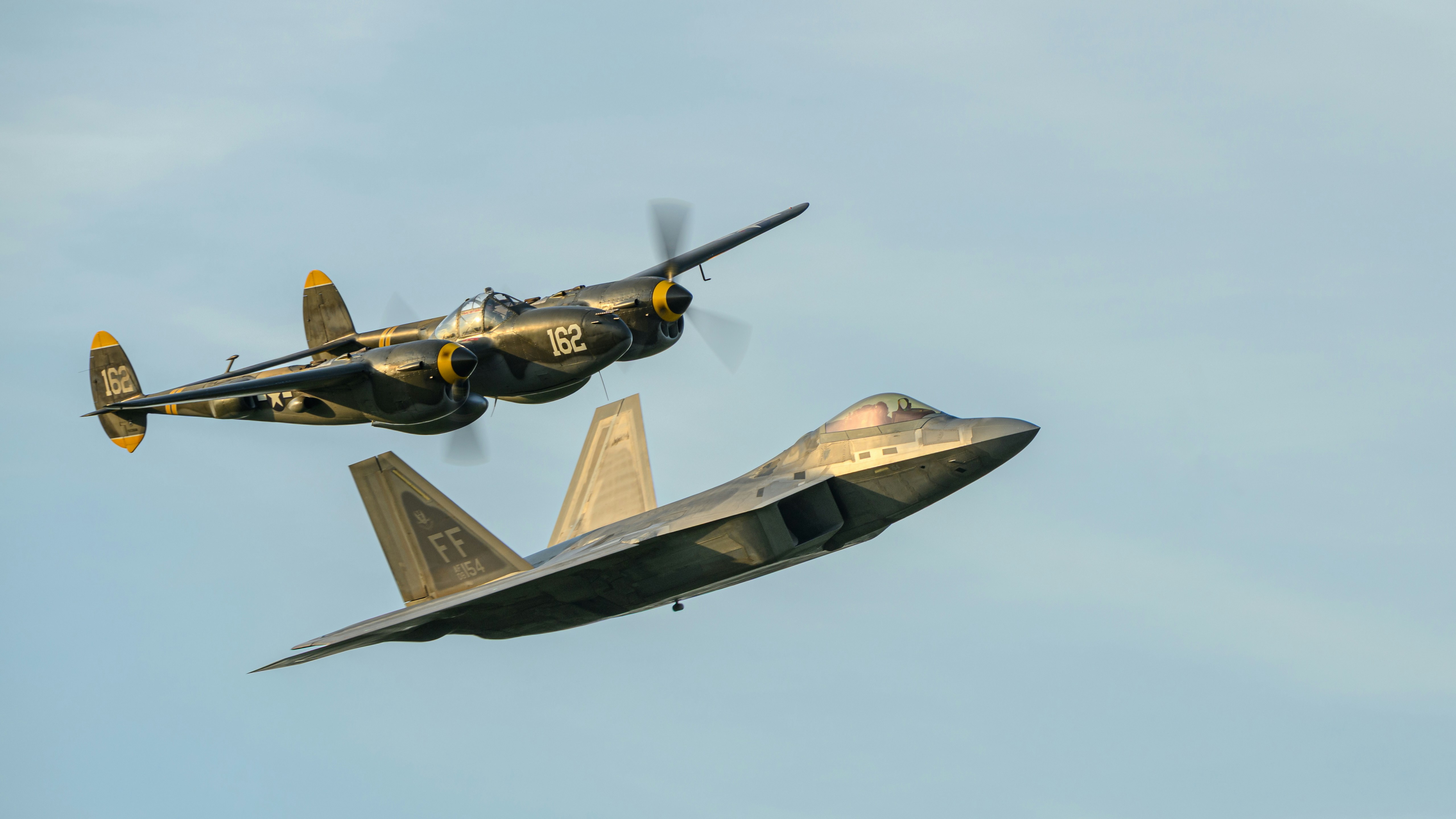 P-38 Lightning and F-22 Raptor formation - Free Photo on Unsplash