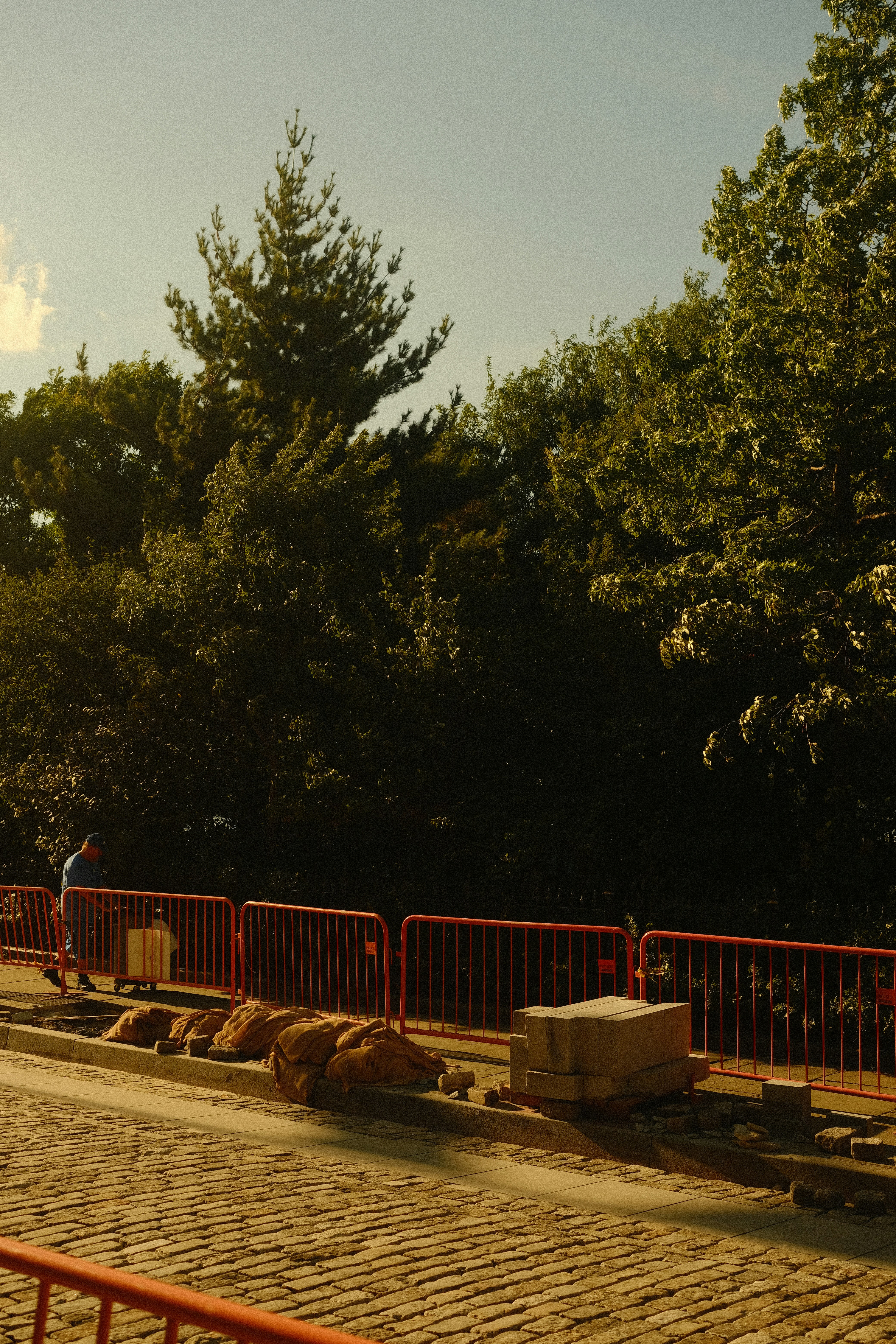 Person walking past red street barriers - Free Photo on Unsplash
