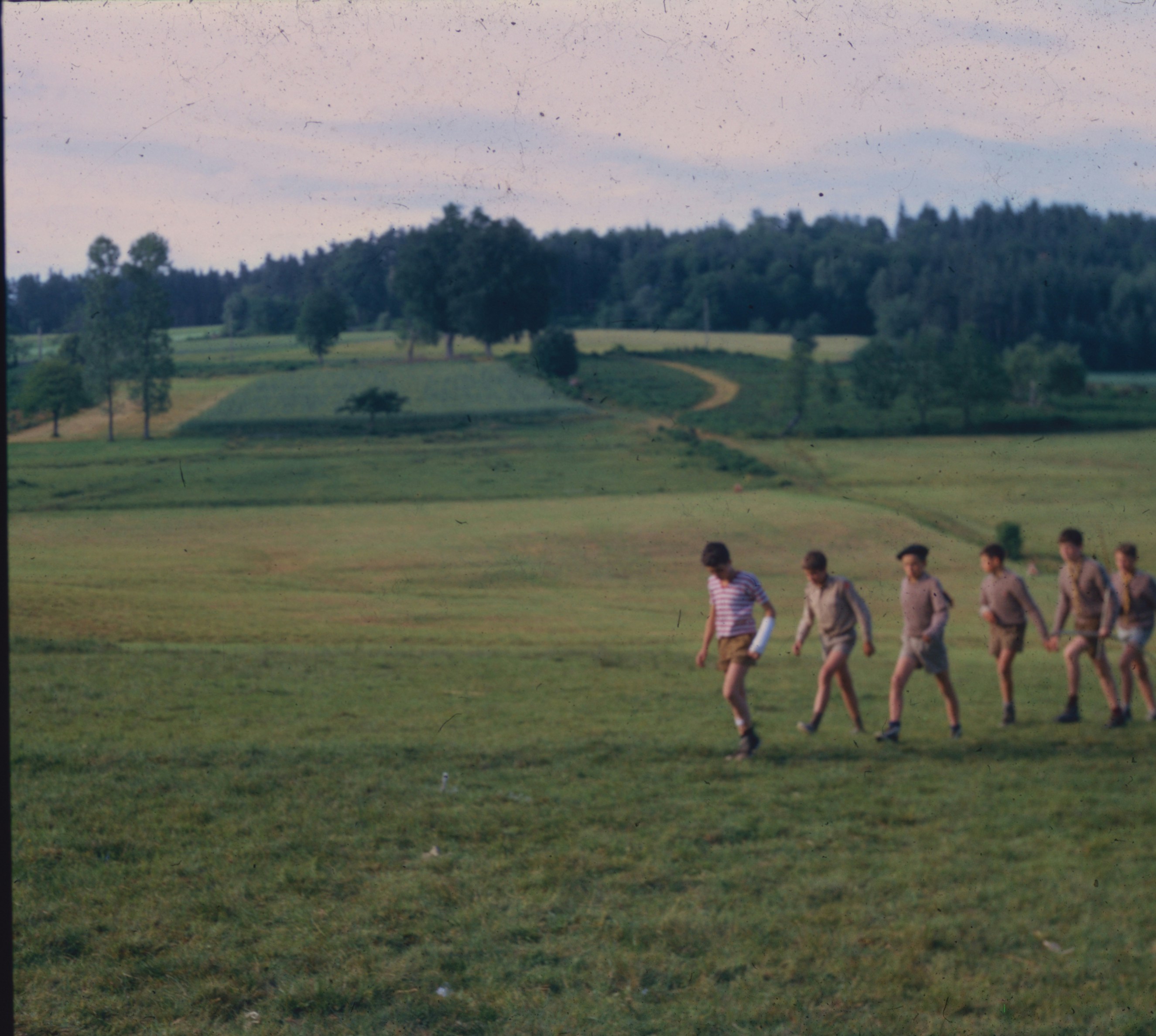 Boys walking across grassy field - Free Photo on Unsplash