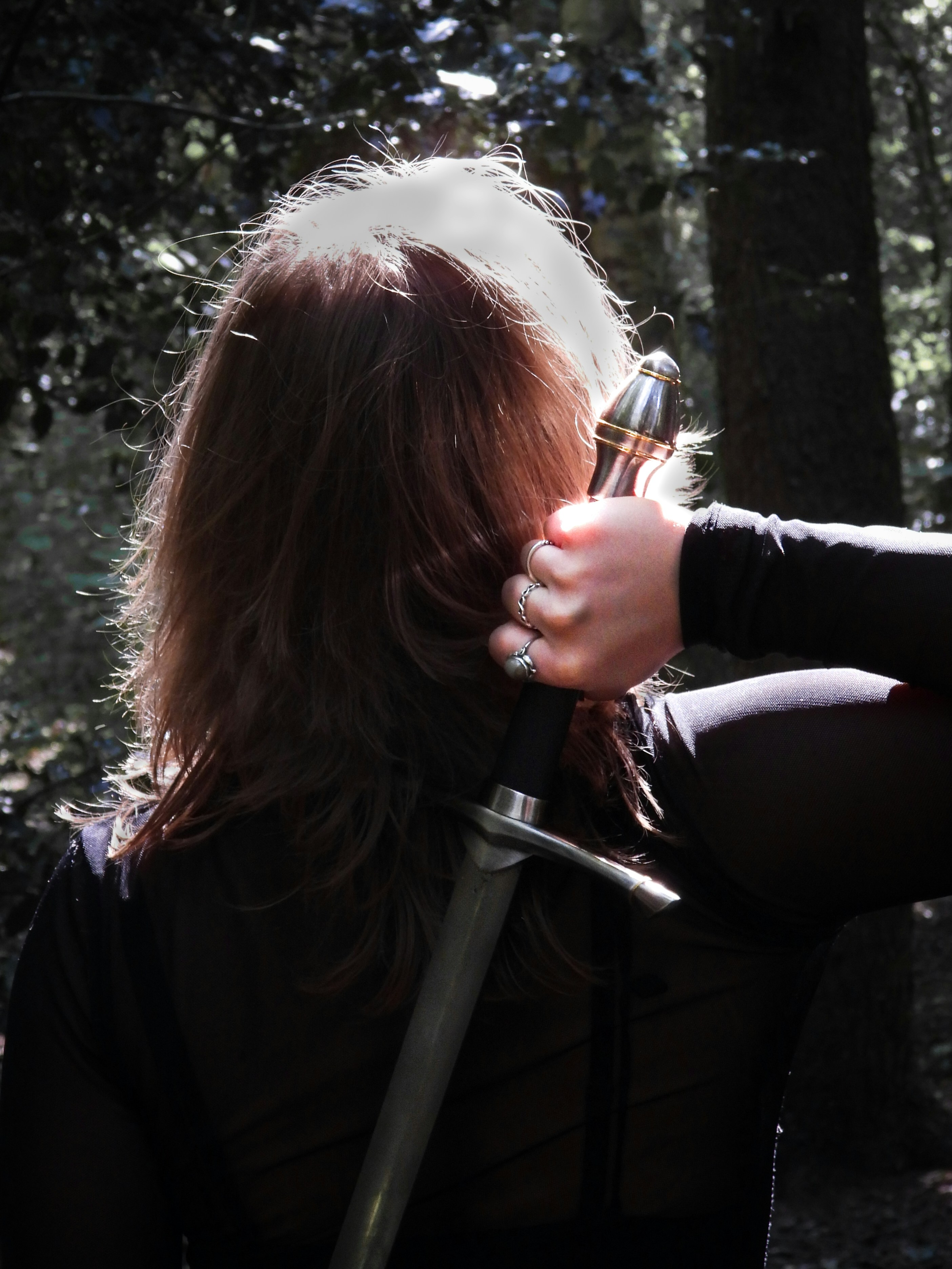Person holding sword in forest - Free Photo on Unsplash