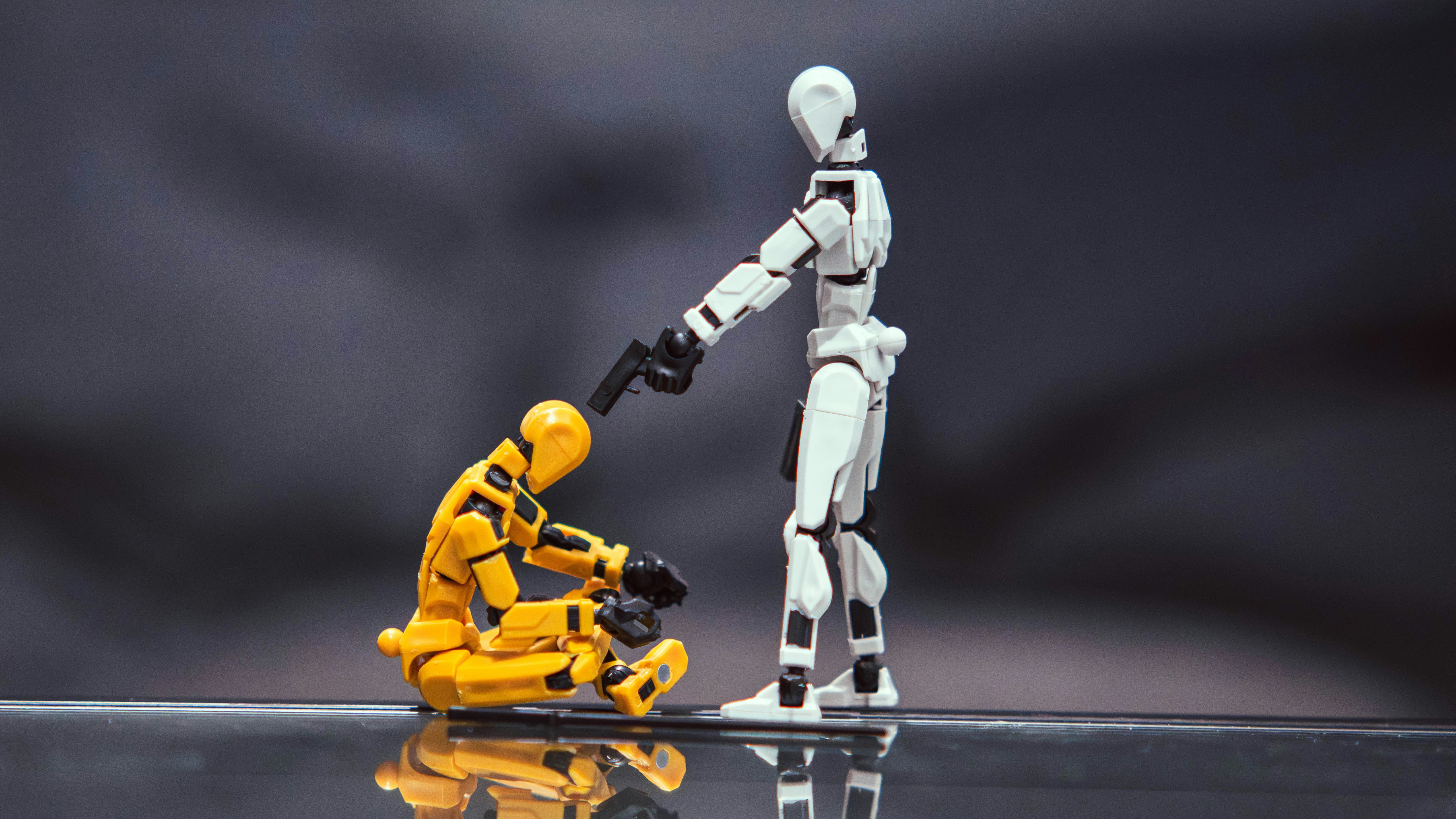 A white articulated figure pointing a gun at a yellow figure on reflective glass