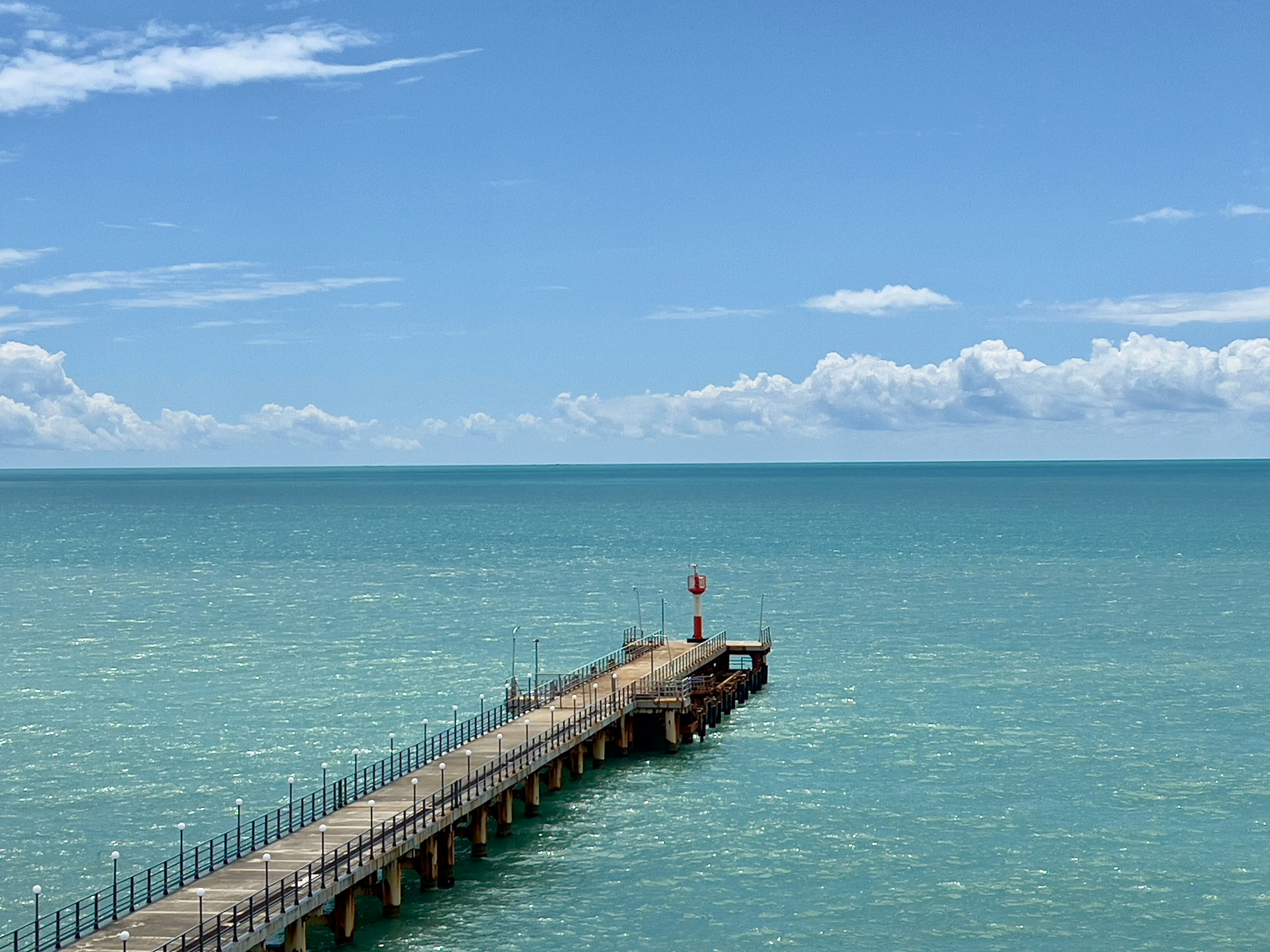 Pier with lighthouse in turquoise water - Free Photo on Unsplash