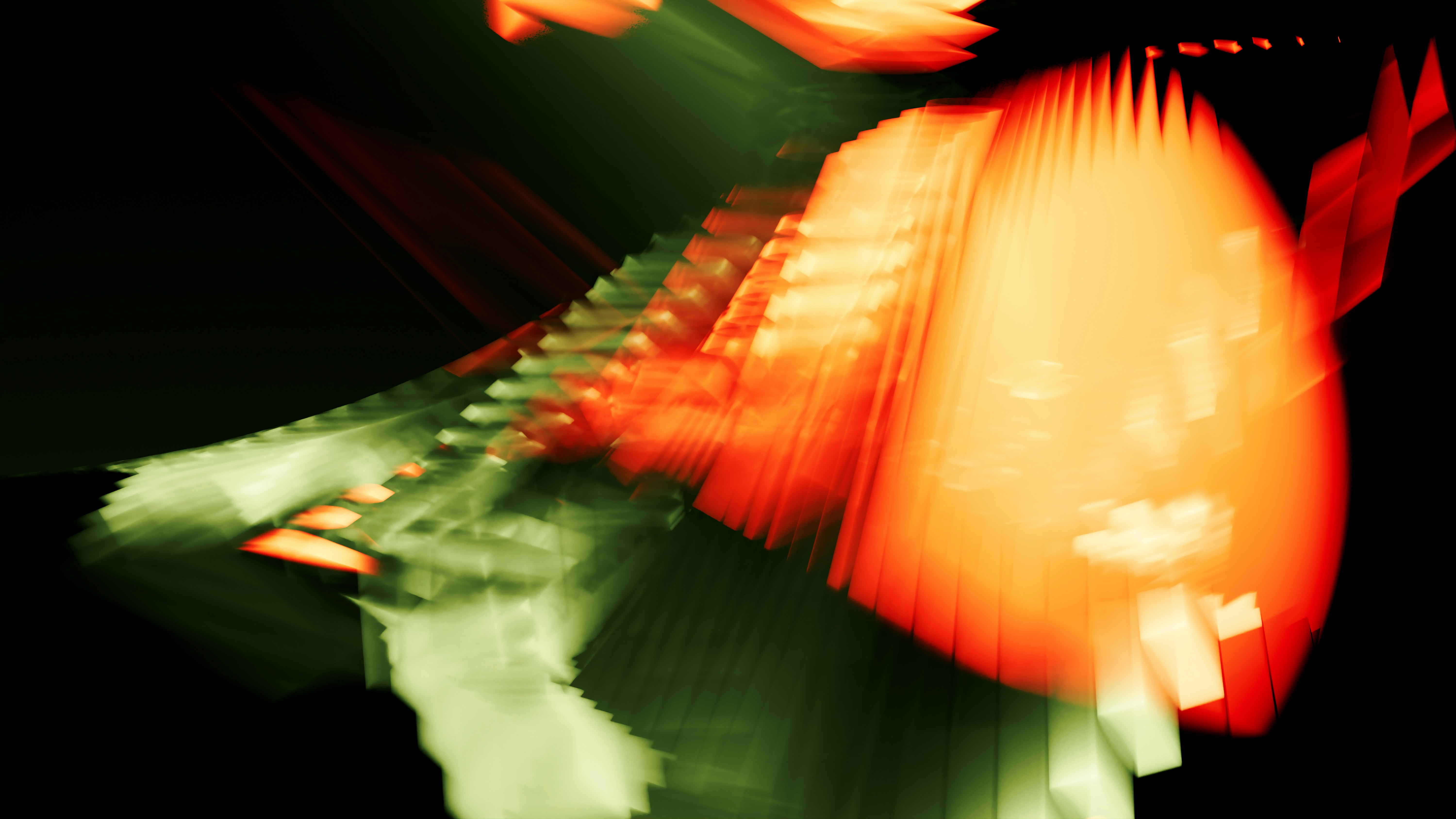 Abstract motion blur of orange and green light streaks against a black background