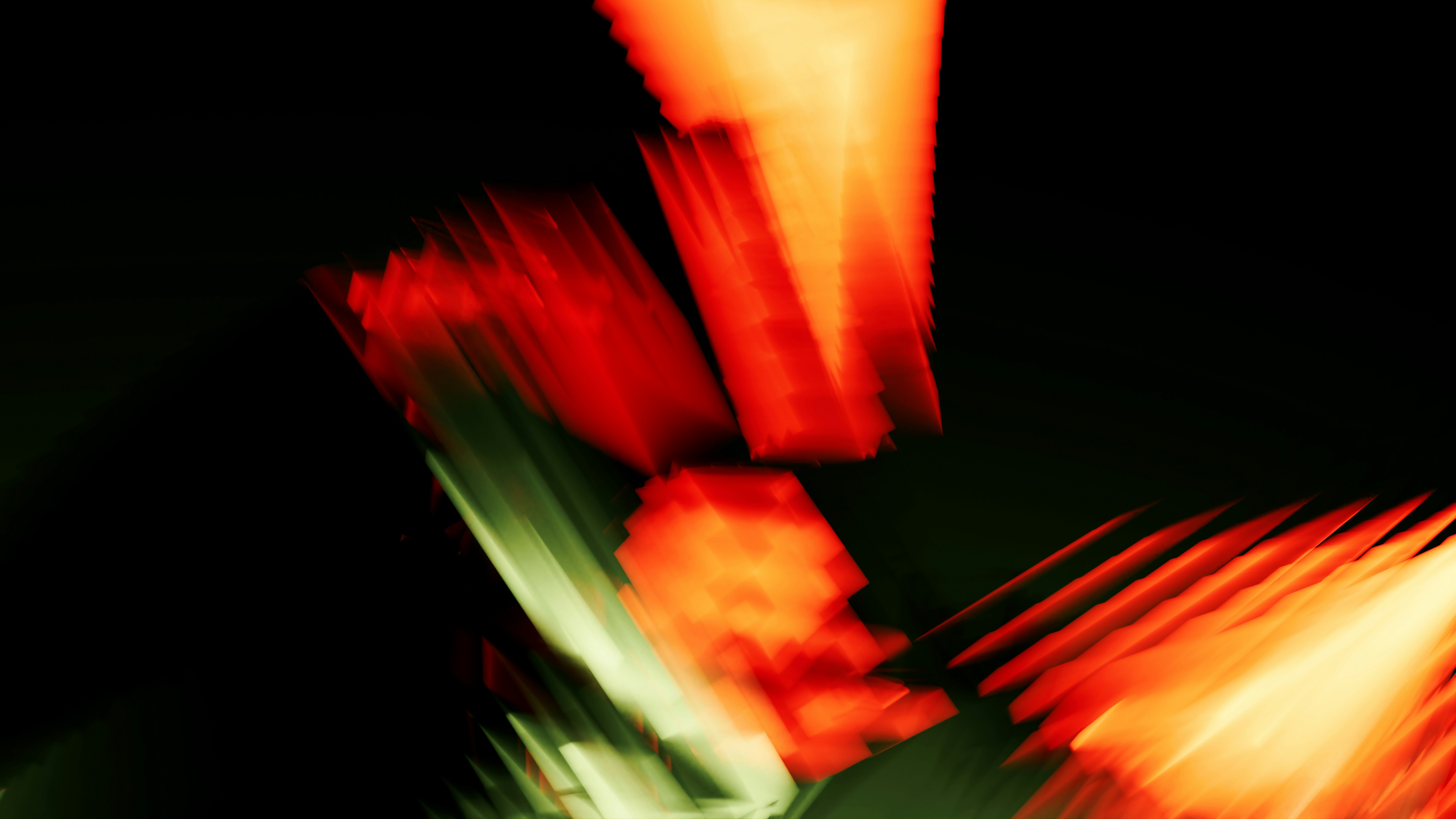 Abstract motion blur of bright red and orange light streaks against a dark background