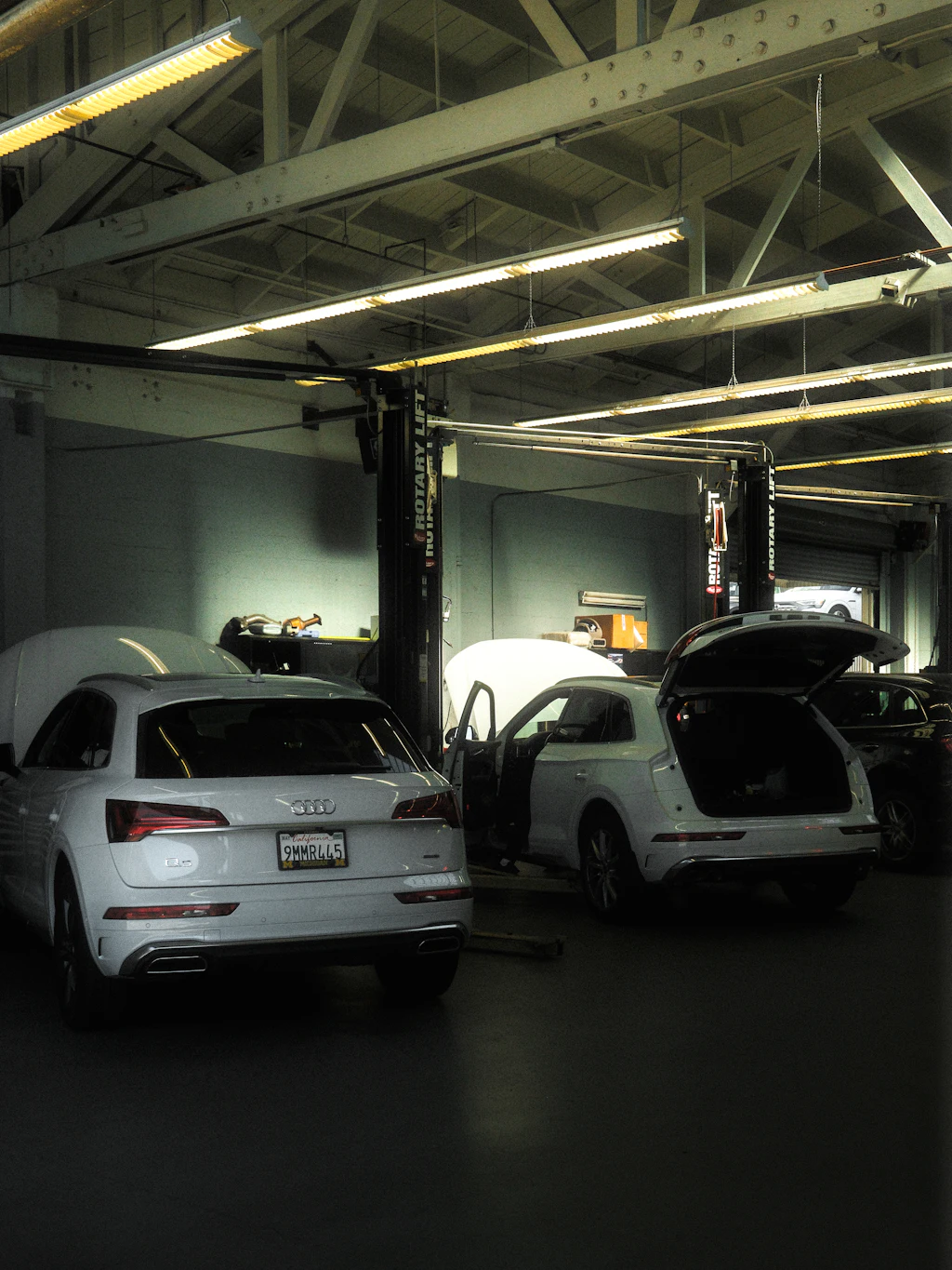 Vehicles inside a bright repair shop