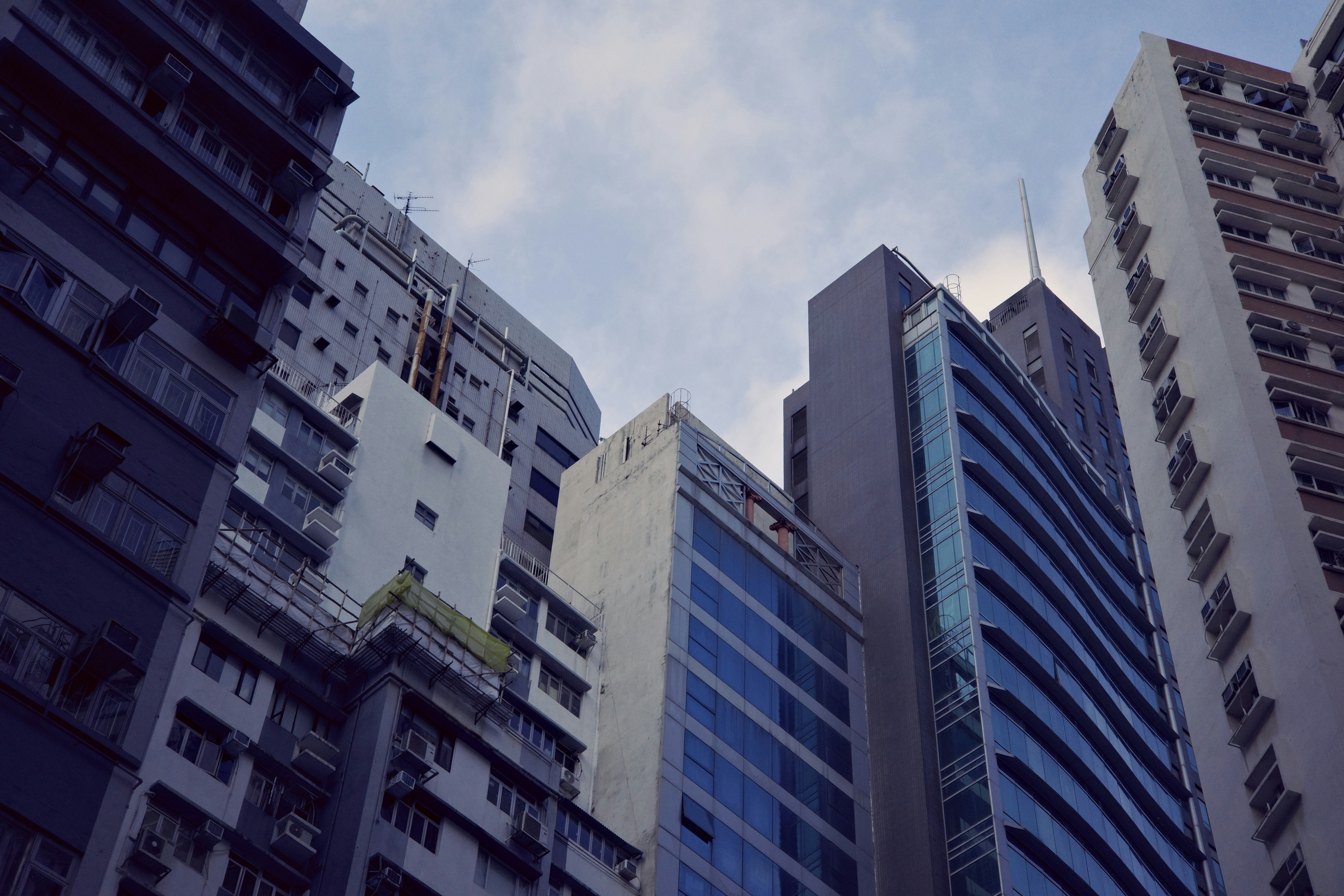 Tall buildings against cloudy sky - Free Photo on Unsplash