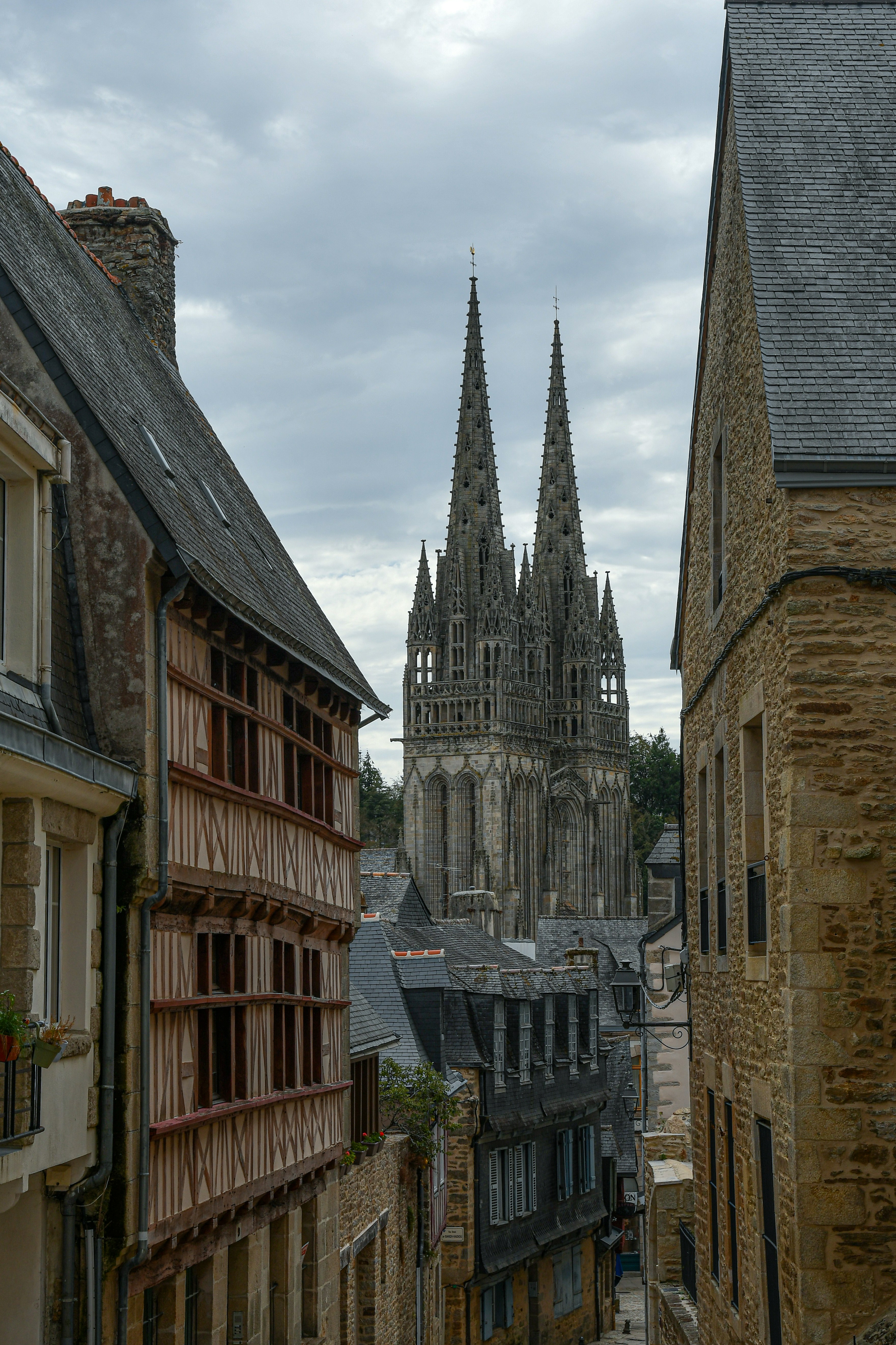 Le due guglie gemelle della Cattedrale di Quimper si ergono sopra storiche case a struttura lignea di Quimper, Francia