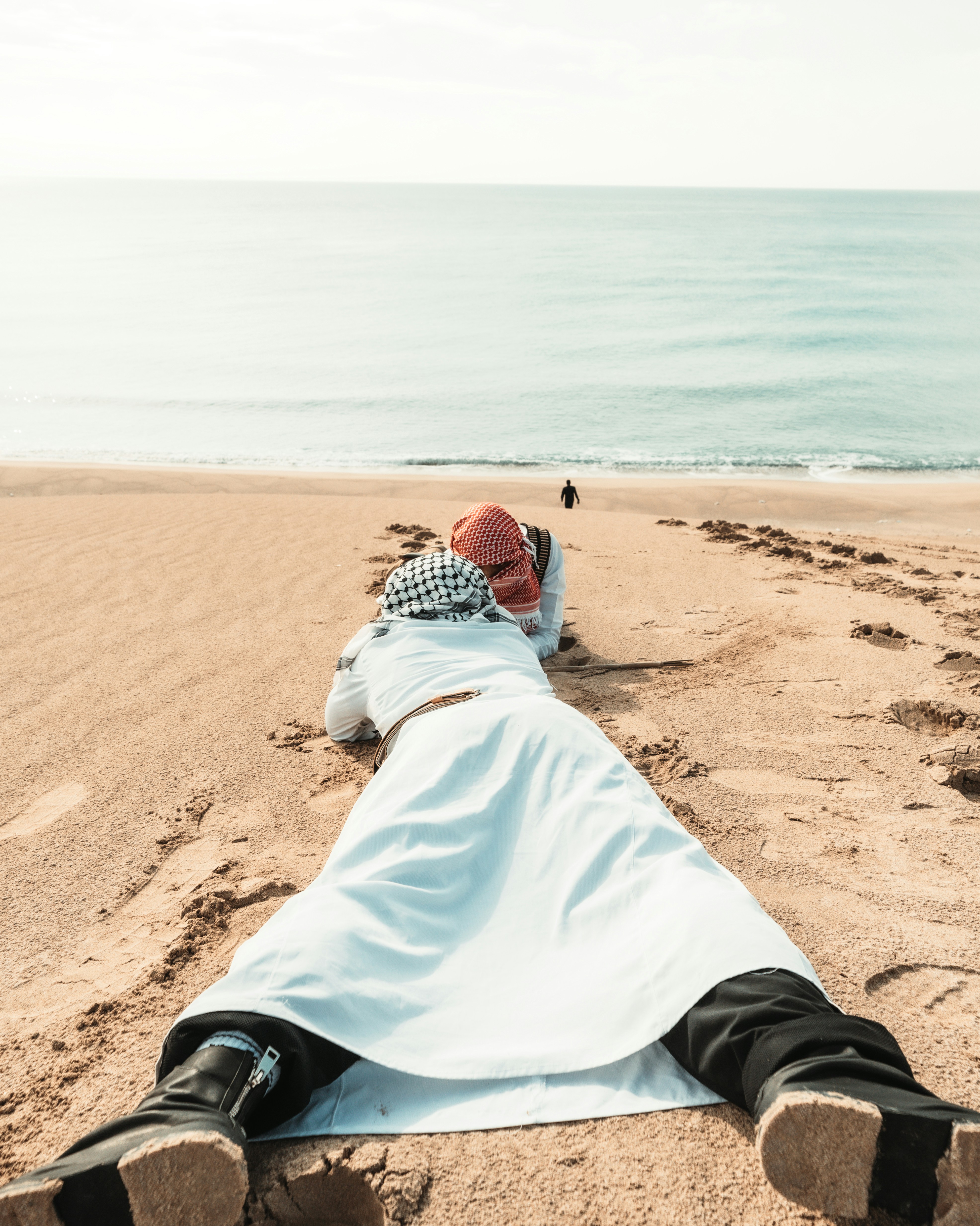 People in traditional robes on beach - Free Photo on Unsplash