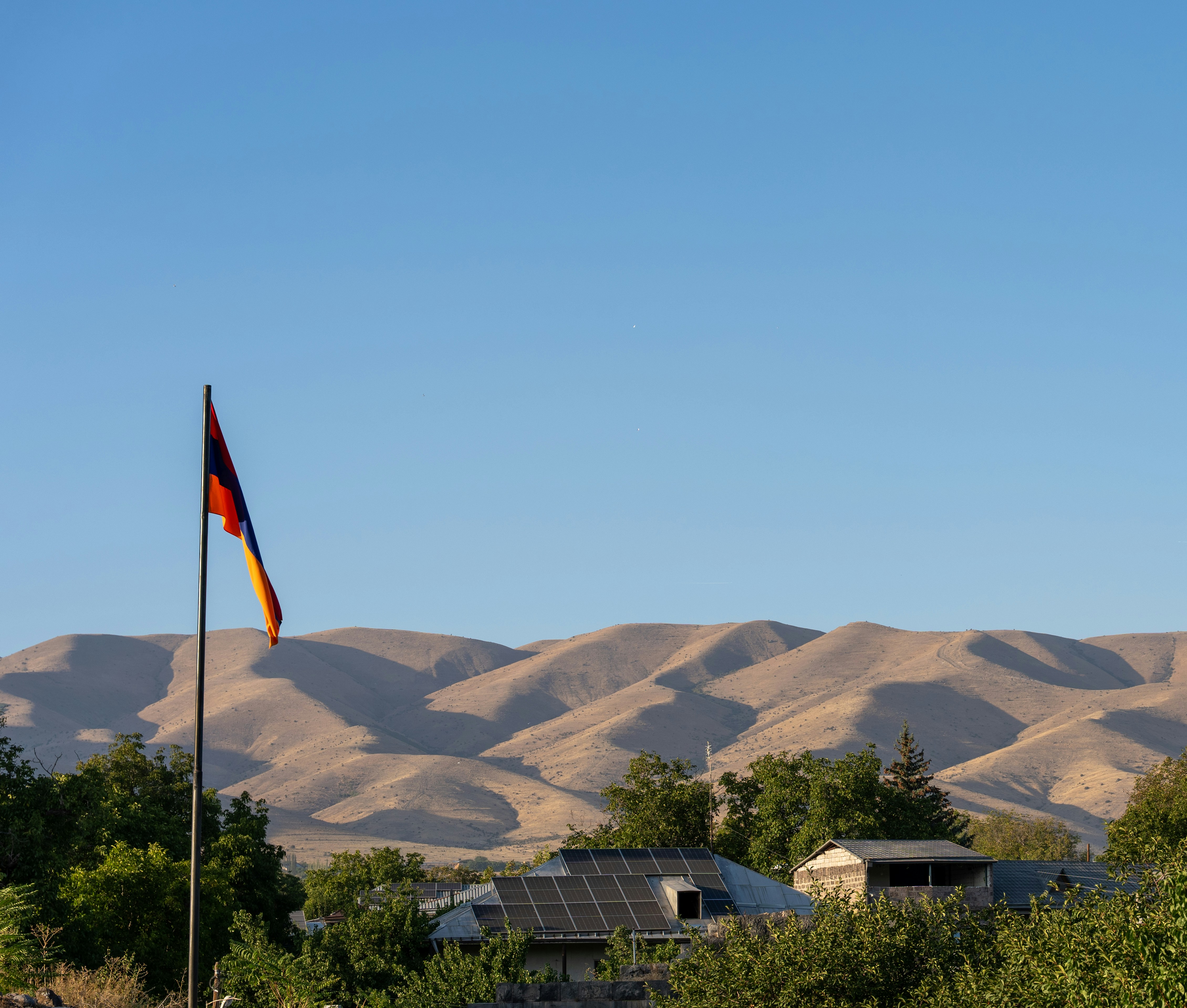 Armenian flag over houses and hills - Free Photo on Unsplash