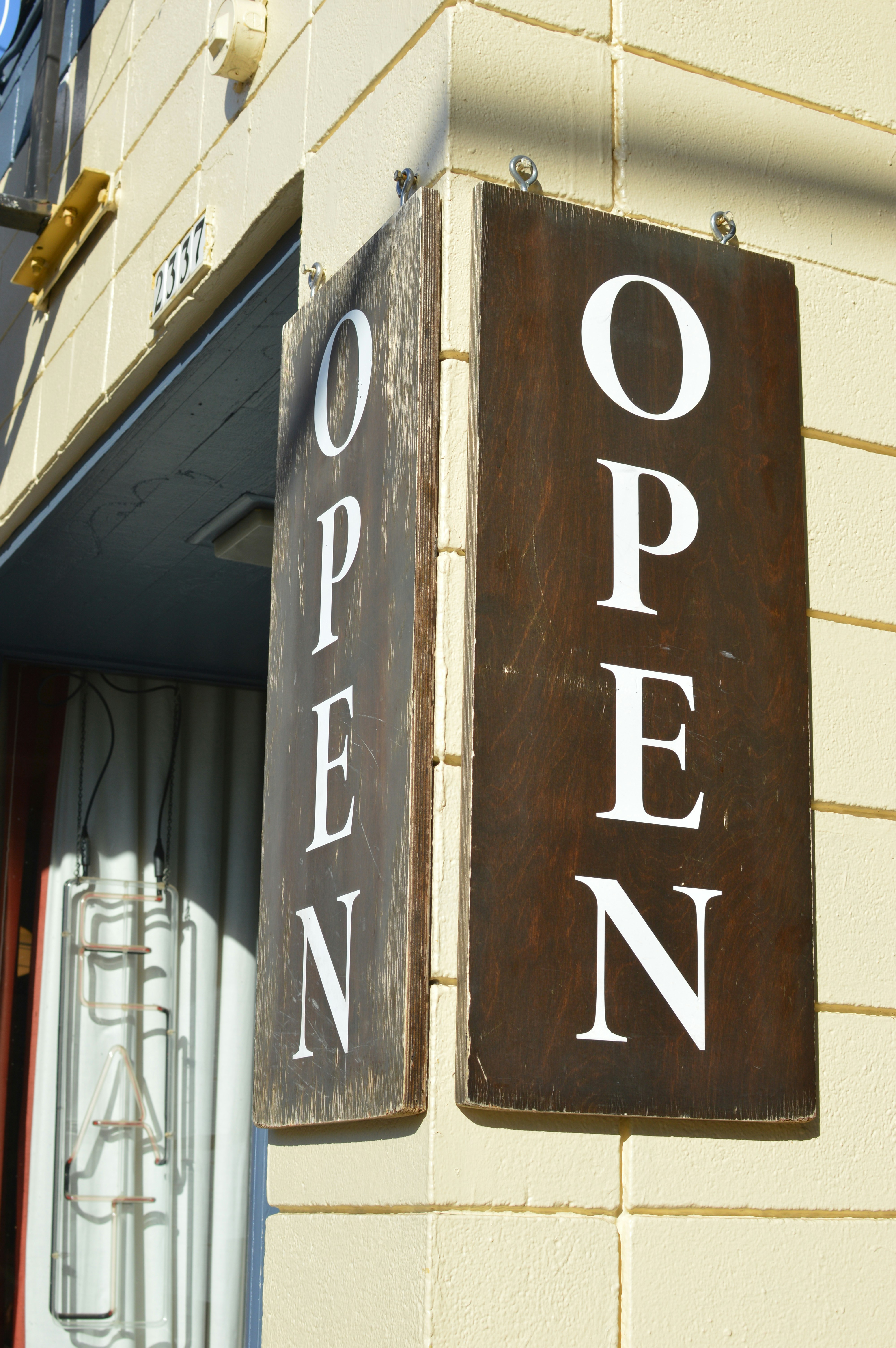 Wooden open signs on building corner - Free Photo on Unsplash