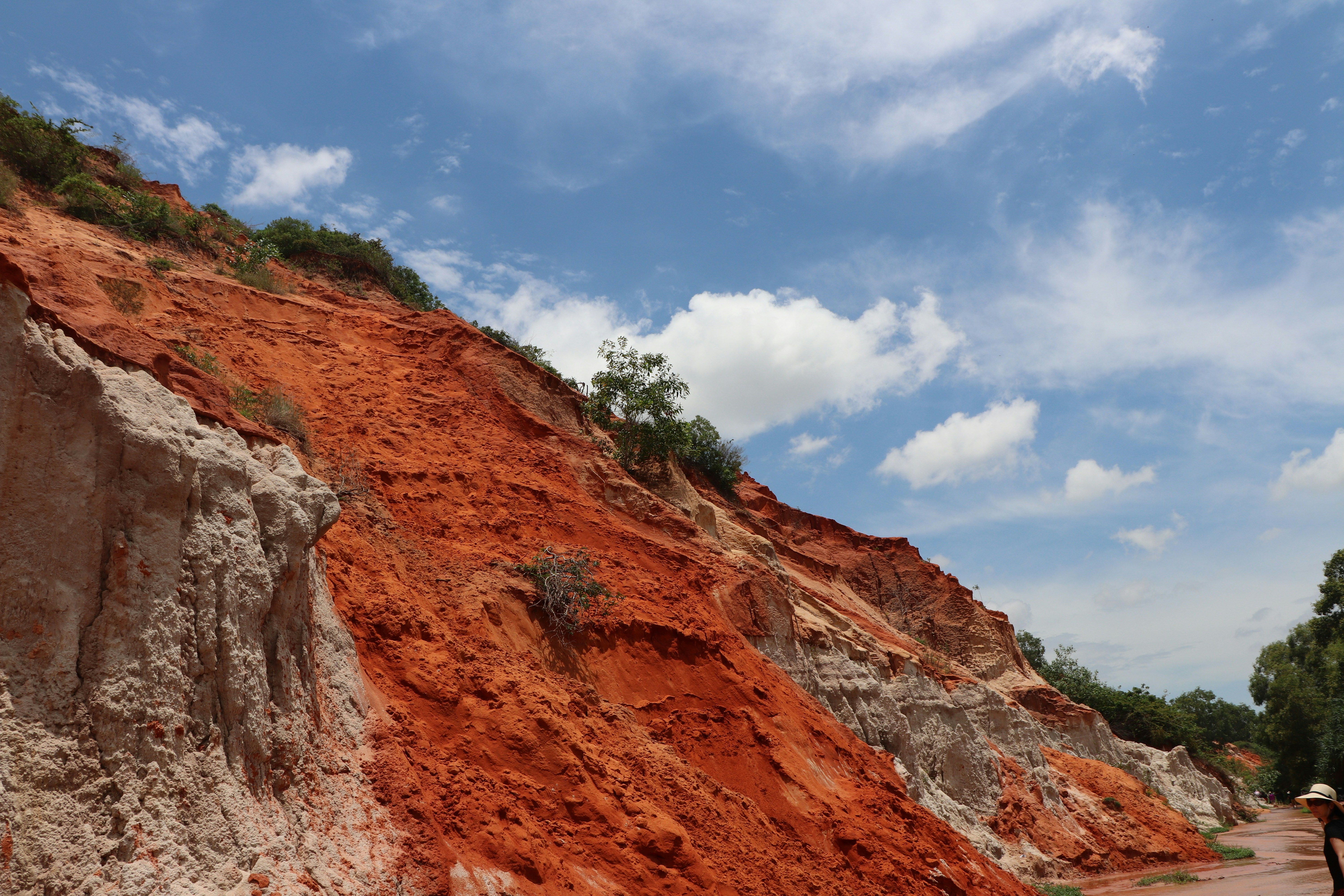 Person walking along red clay canyon - Free Photo on Unsplash