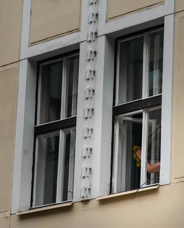 Window being cleaned from inside an older building