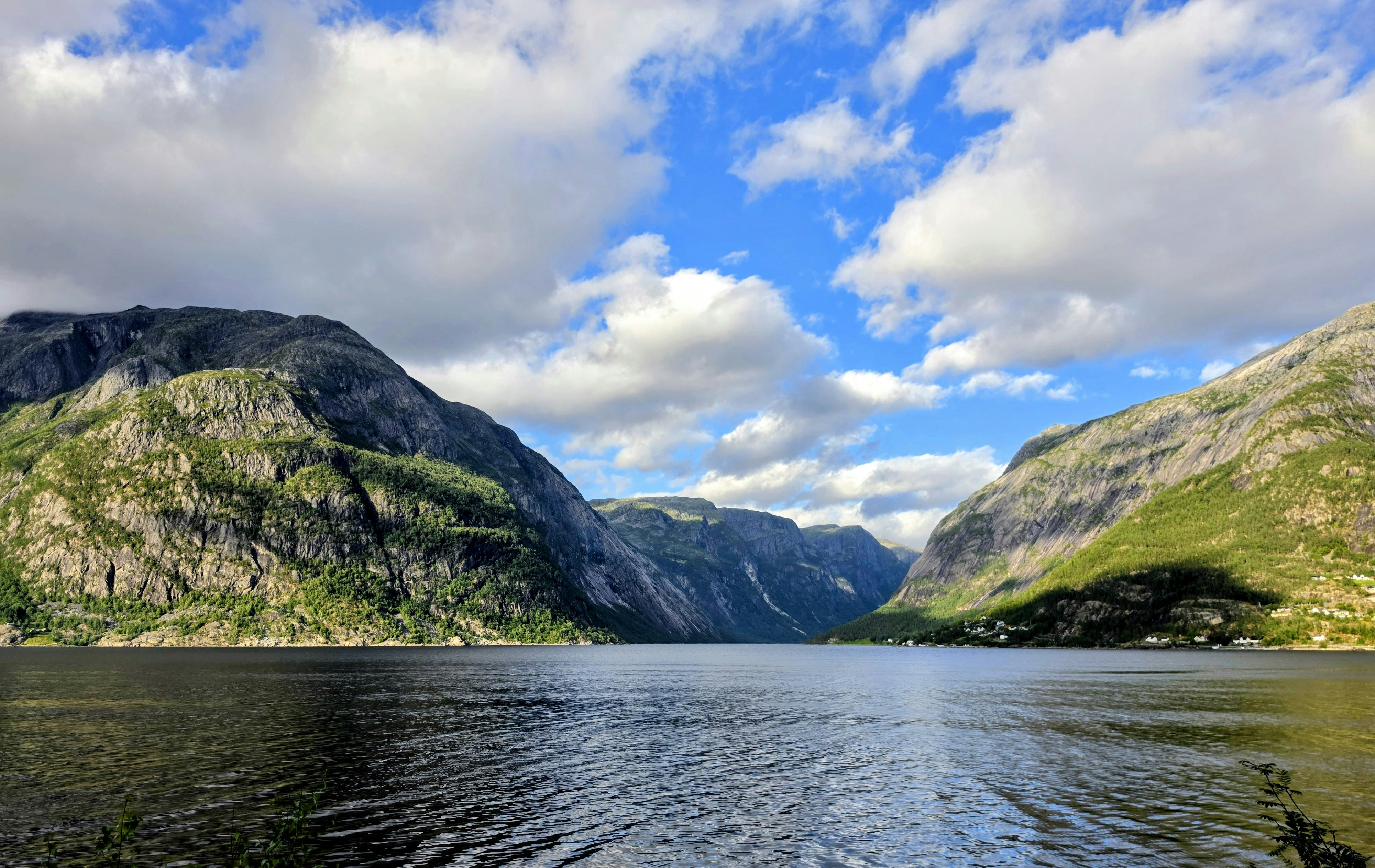 Steep mountains surrounding deep blue fjord - Free Photo on Unsplash