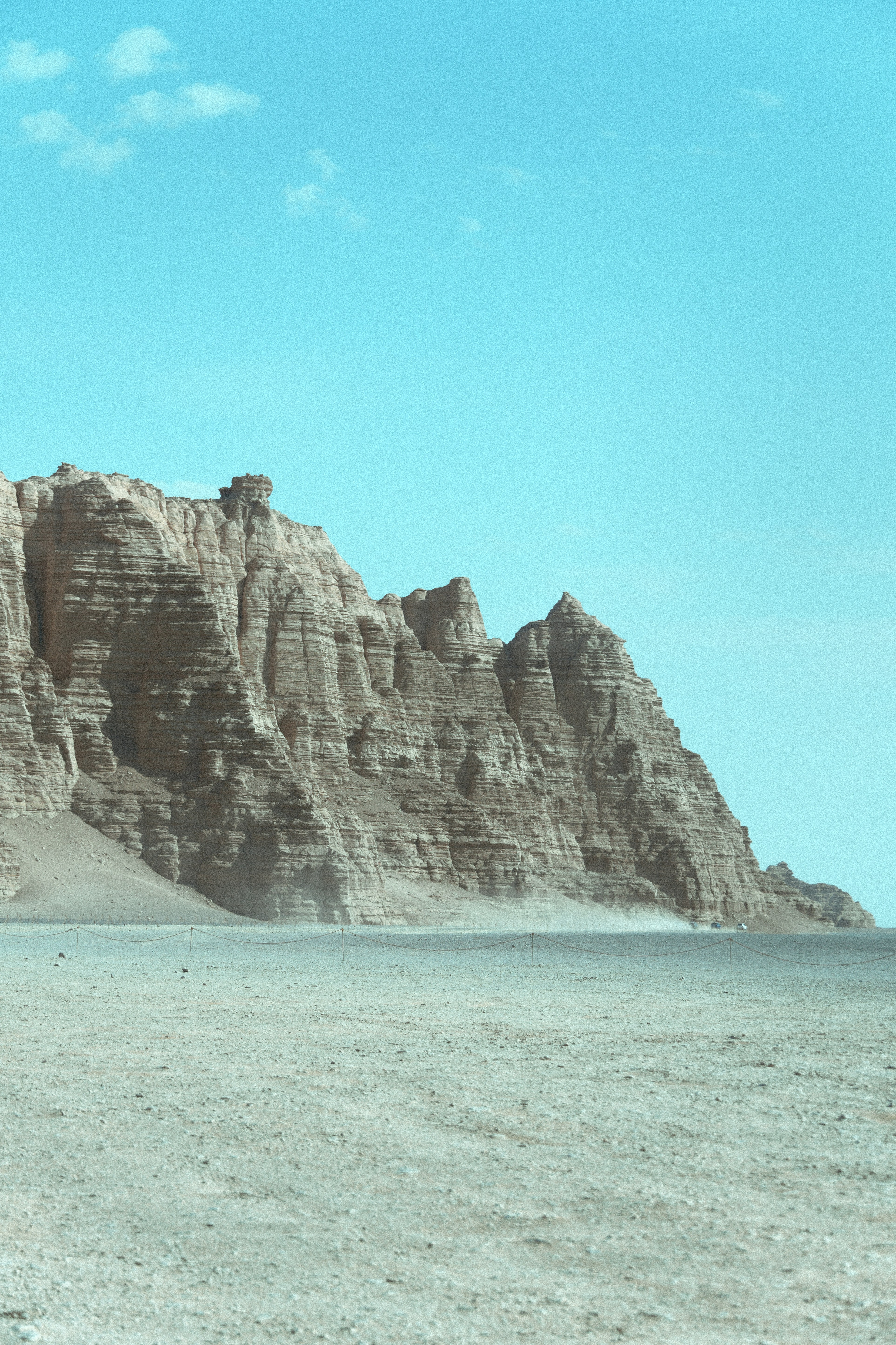 Rocky cliff face above desert plain - Free Photo on Unsplash