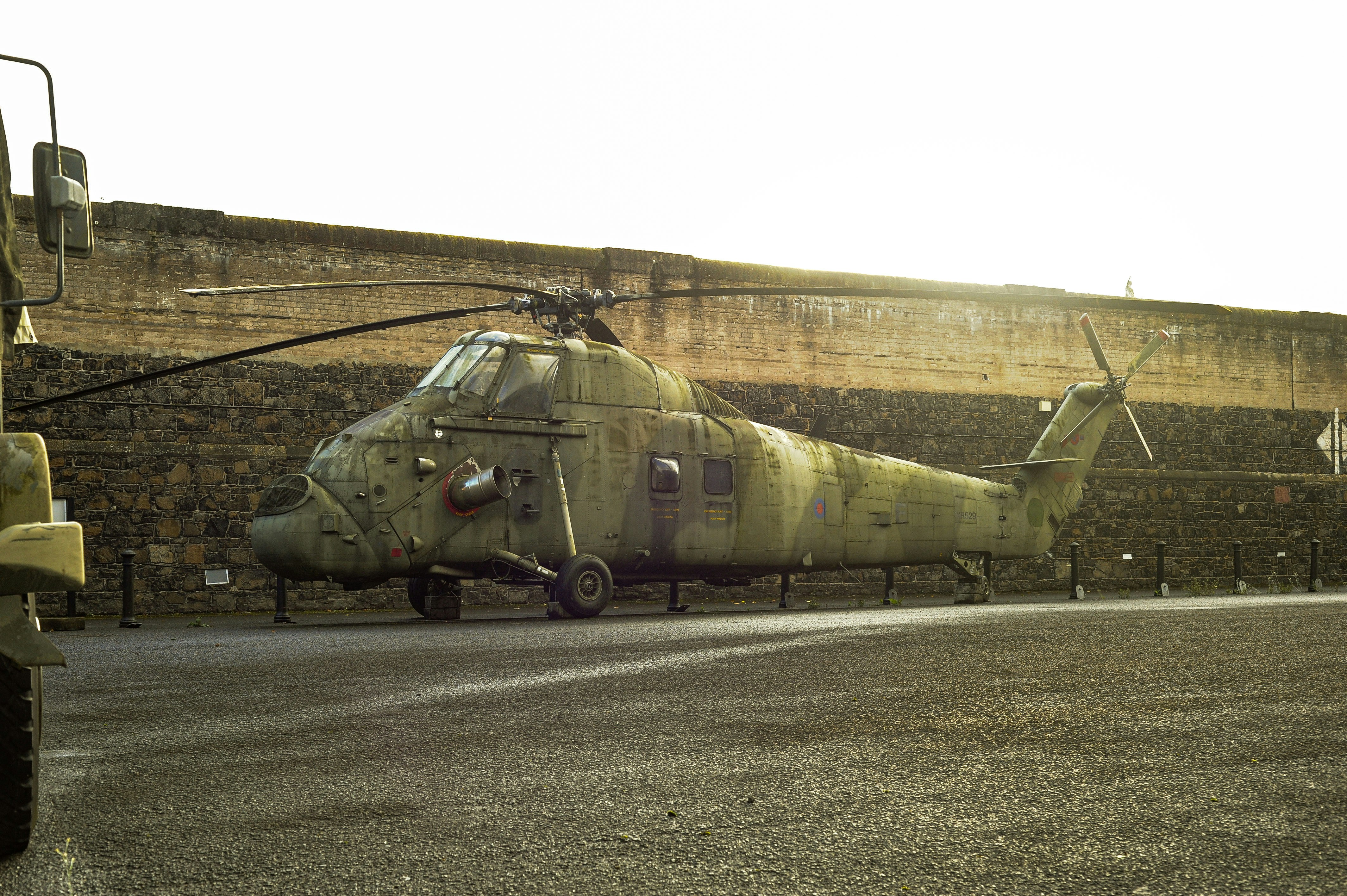 Weathered military helicopter on asphalt lot - Free Photo on Unsplash