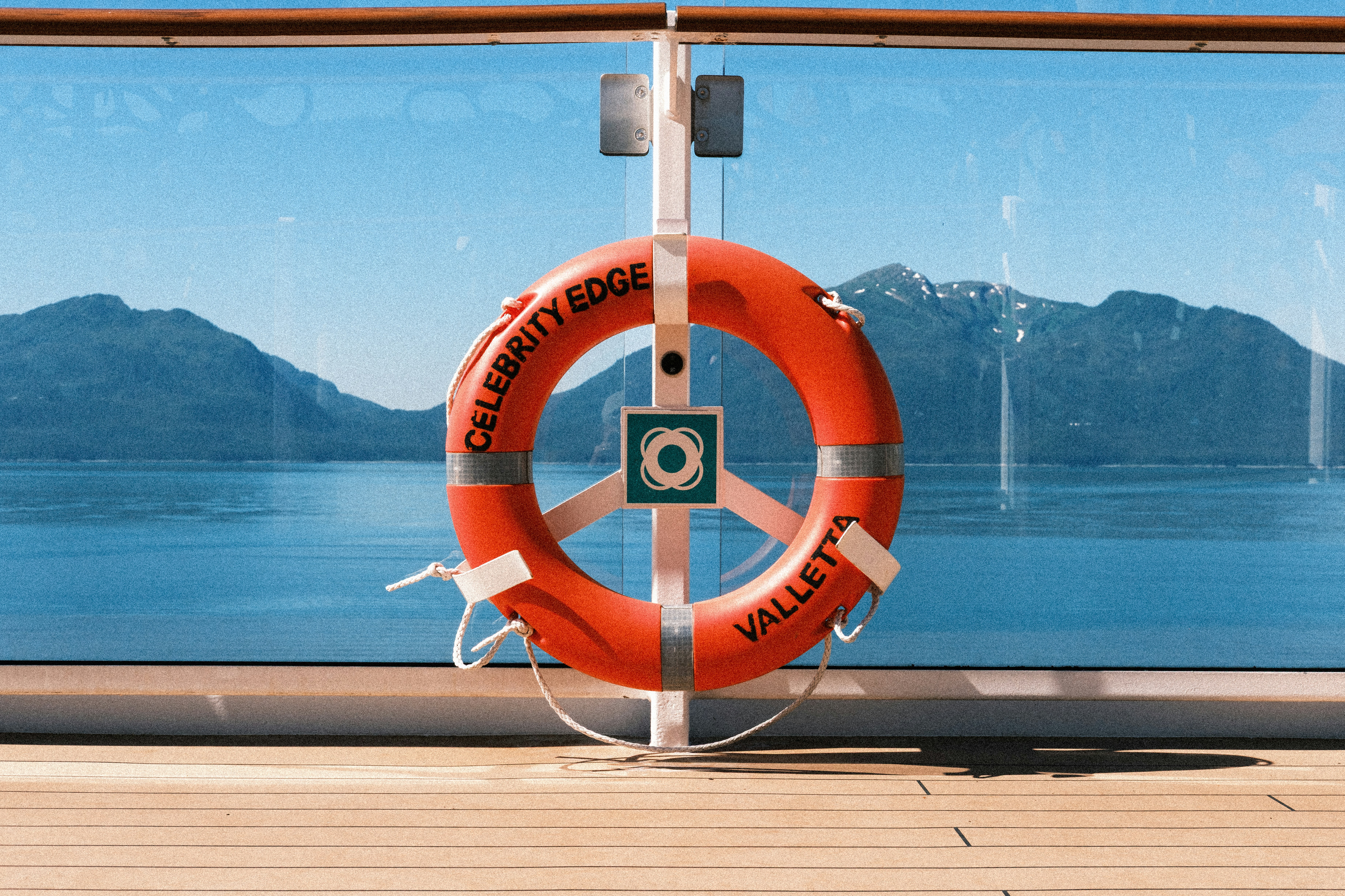 Orange lifebuoy on cruise ship railing - Free Photo on Unsplash