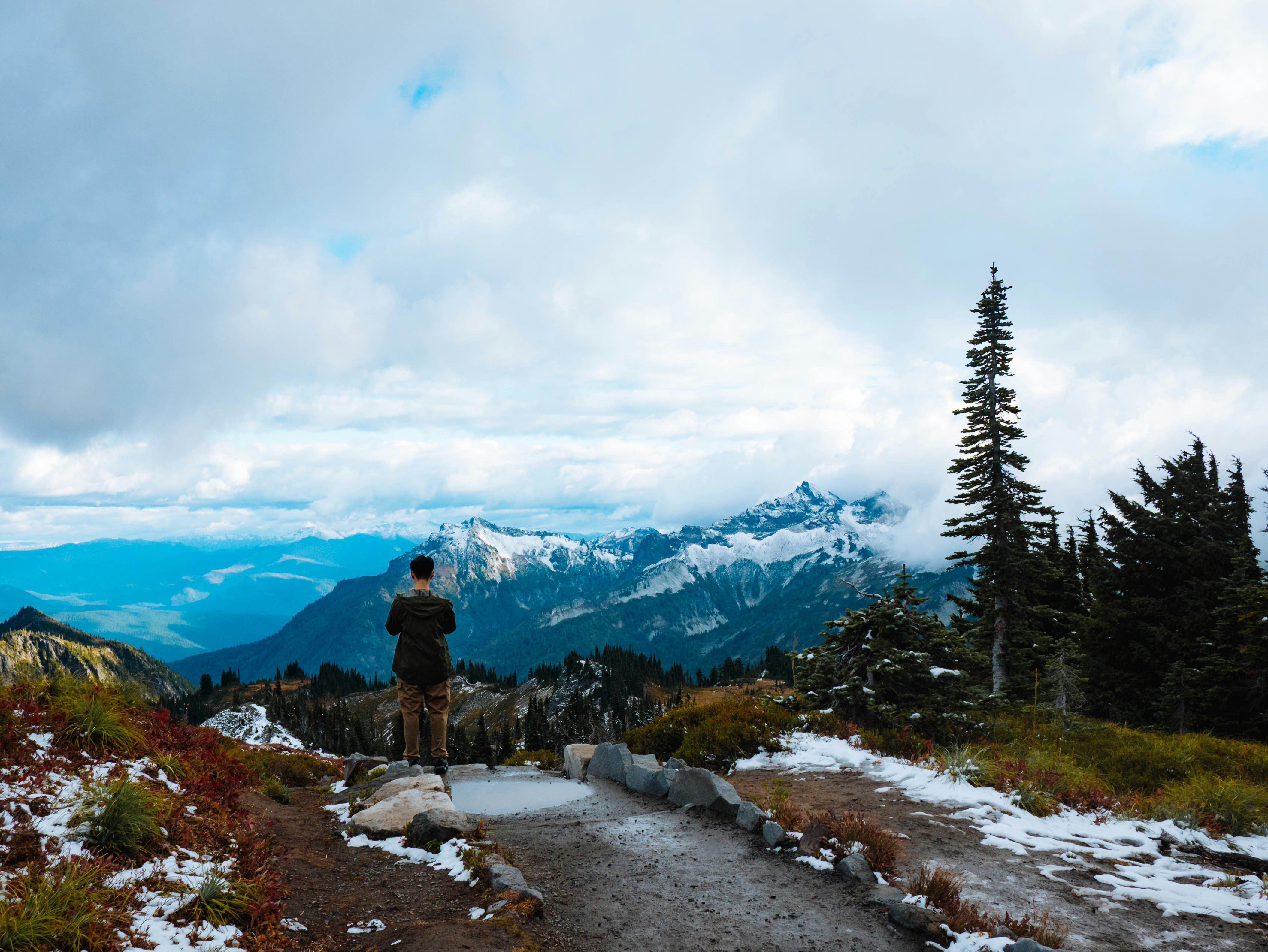 Person looking at snow-capped mountains - Free Photo on Unsplash