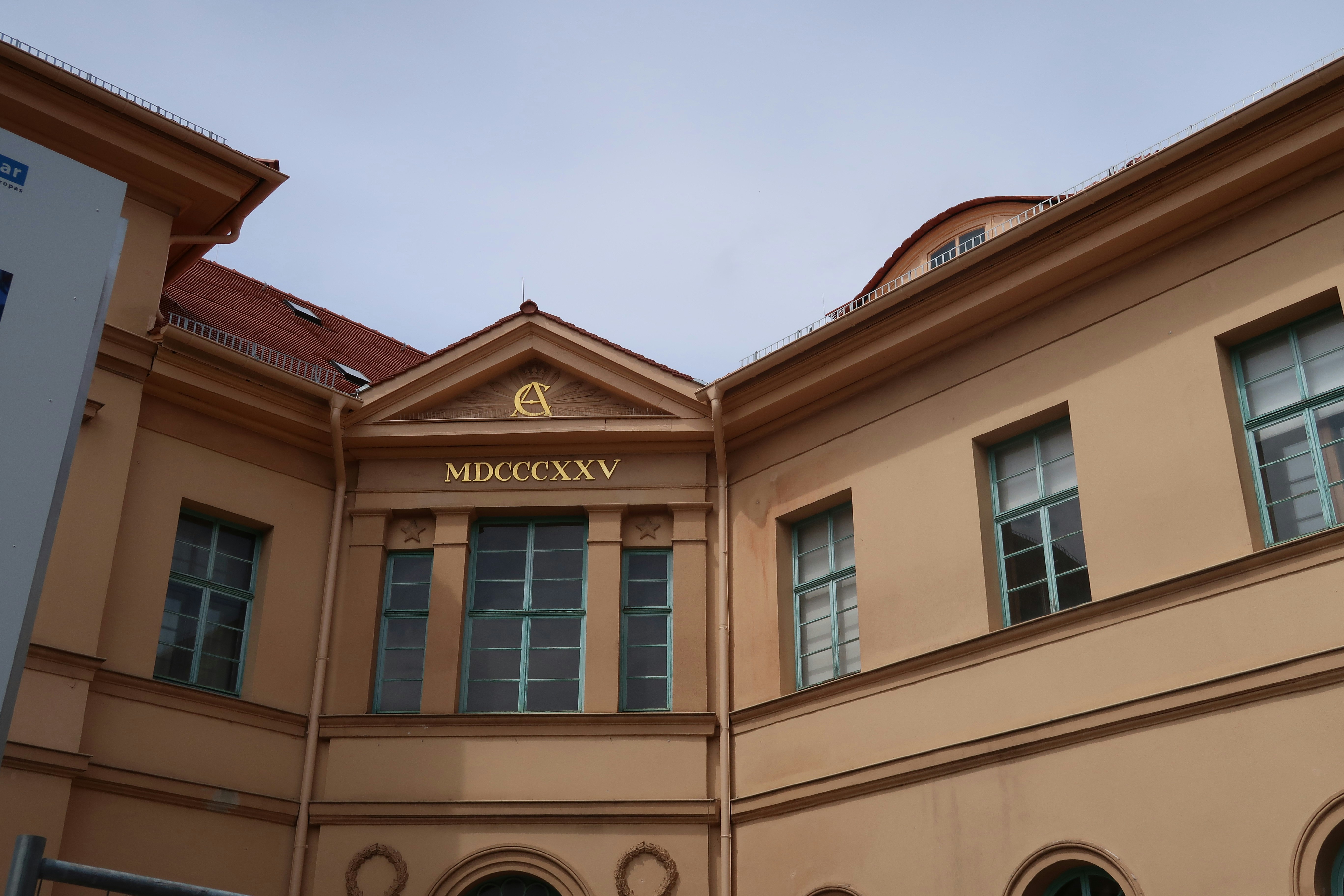 Tan building facade with Roman numerals - Free Photo on Unsplash