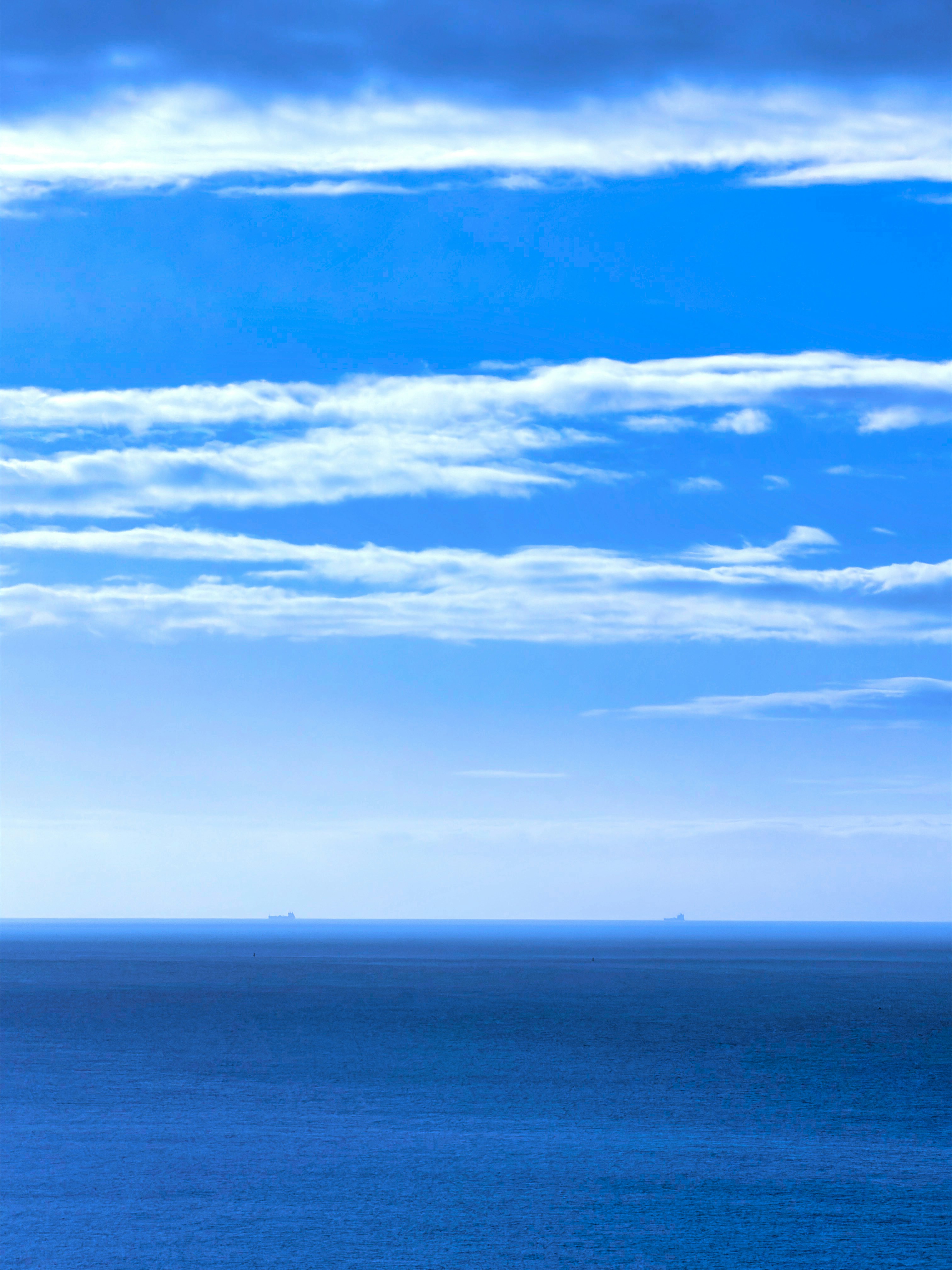 Blue ocean under horizontal clouds - Free Photo on Unsplash