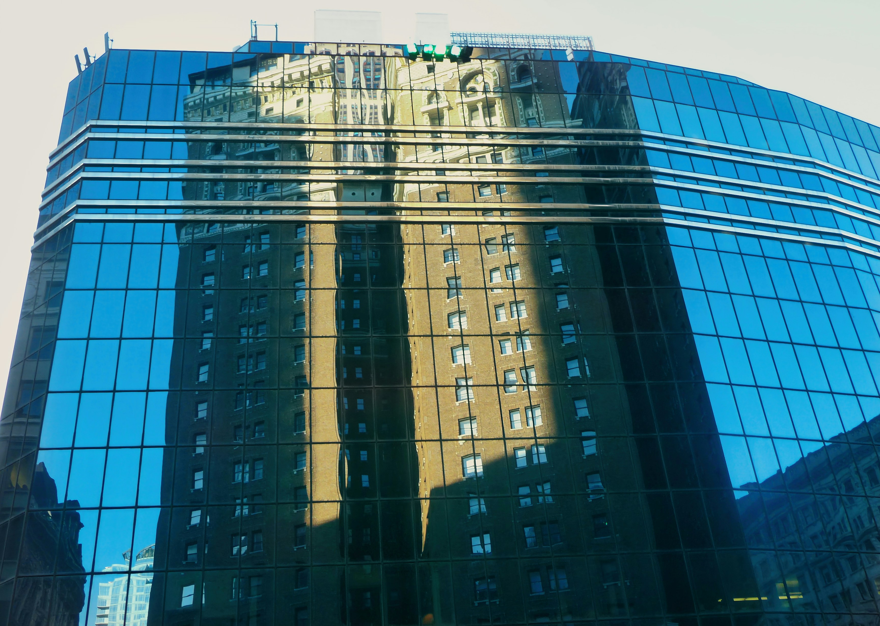 Historic building reflected in glass skyscraper - Free Photo on Unsplash