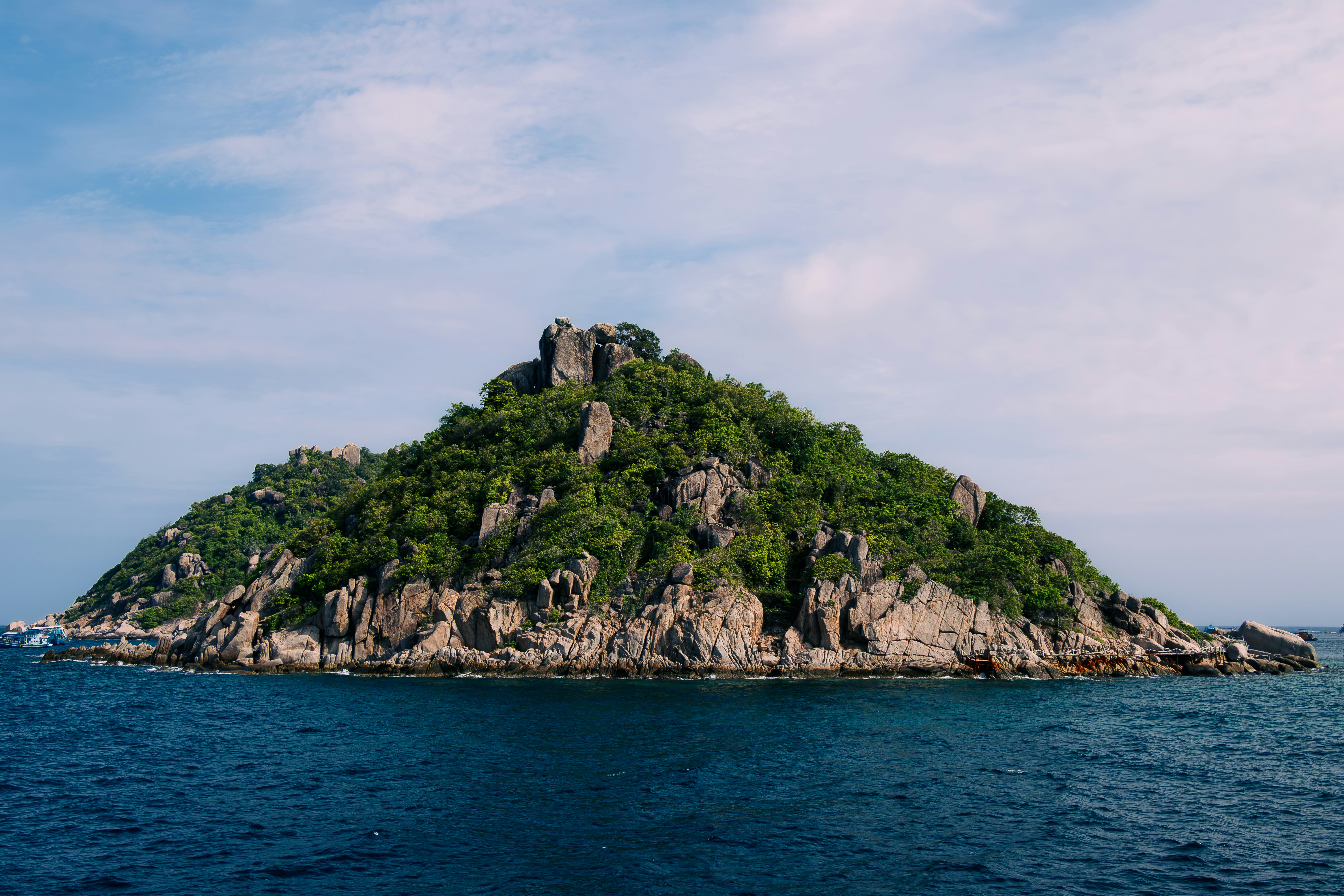 Rocky island in blue ocean - Free Photo on Unsplash