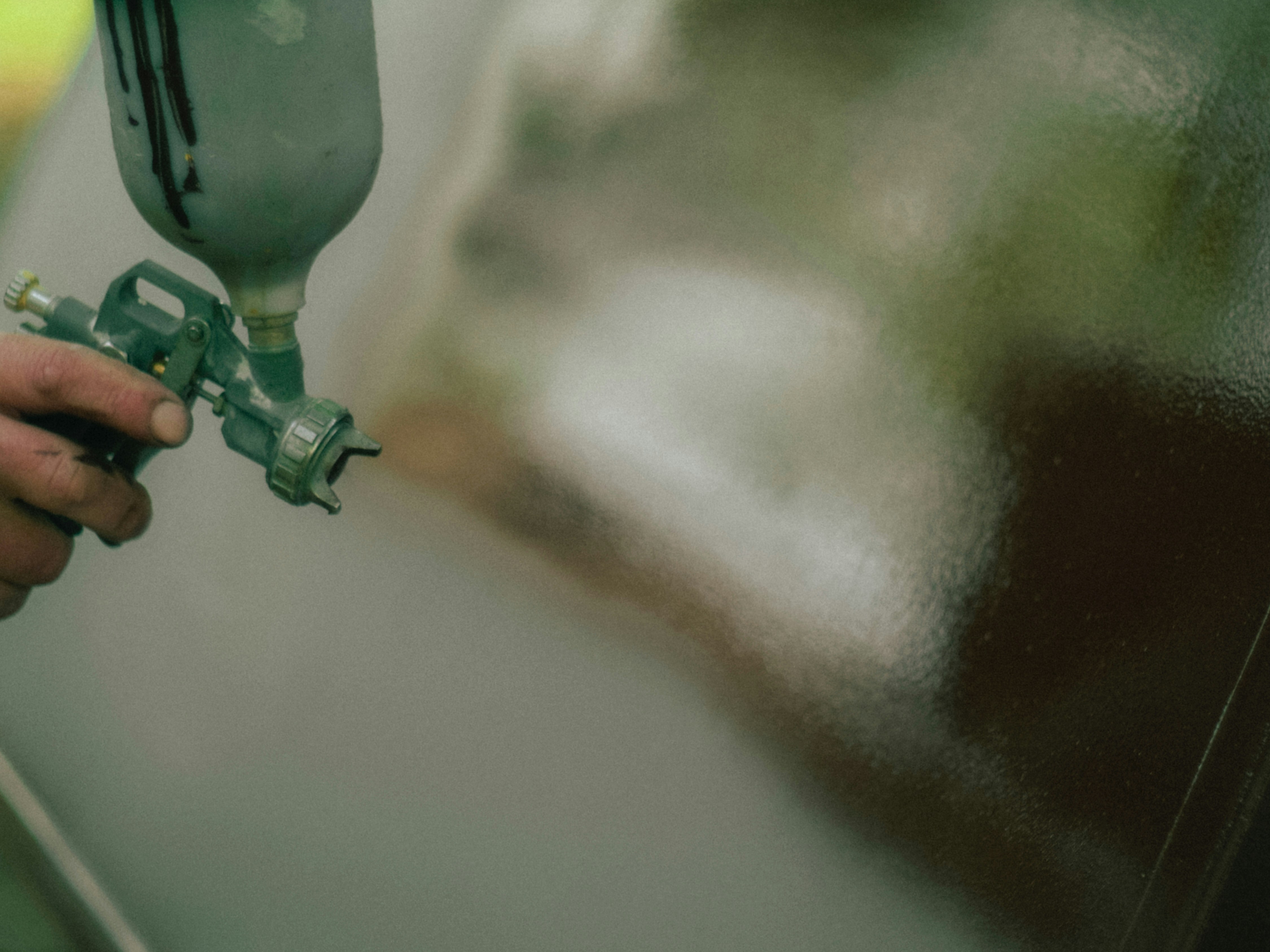 Hand using spray gun on surface - Free Photo on Unsplash